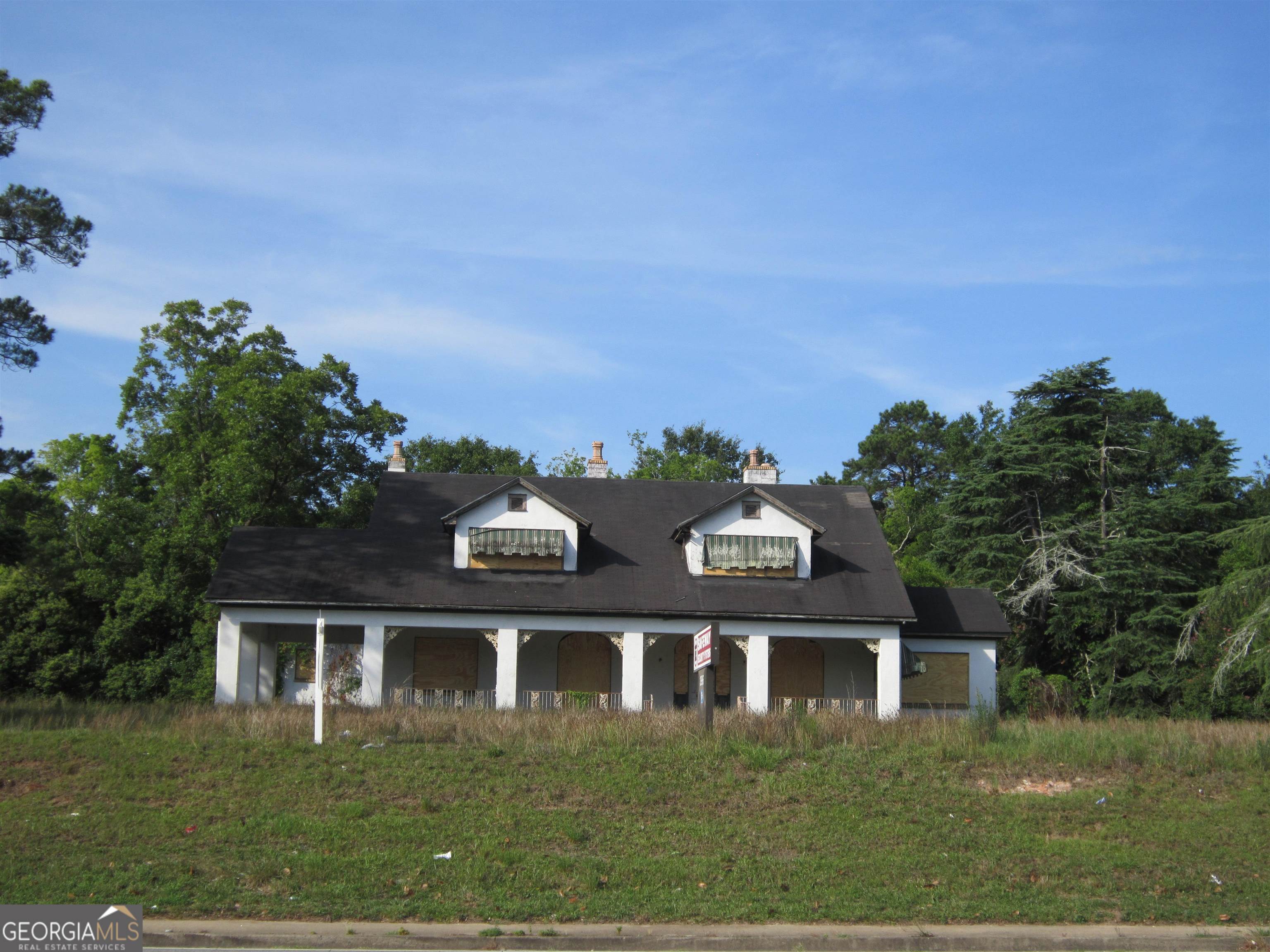 Back on the Market no fault of the seller! Come & Bring Your Best Offer! Great commercial property for sale. Prime location with easy access to Hwy 74 & I-475 in Macon, GA. The sale includes the following: Main building 2203 sq ft; Build 1 offers 1104 sq ft with various usage; Building 2 offers additional storage usage. This 3.94 acre offers multiple use options for event planning/catering service, doctor/dentist office; student center/housing, multifamily units or bring your contractor along with your creative design. Interior picture available upon request. Call today to schedule your showing appointment at 678-858-7812