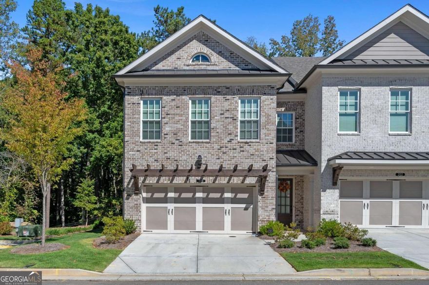 Experience refined sophistication in this better-than-new, move-in-ready end-unit townhome, a true gem of Johns Creek. Built in 2024 and upgraded with over $150,000 in high-end finishes, this residence blends modern luxury with timeless elegance.    Enjoy the space and comfort of a single-family home without the hassle of constant maintenance. With a low $235 monthly HOA covering lawn care, roof, and exterior upkeep, you can focus on living beautifully and effortlessly.    Step inside to find soaring ceilings, 9-foot doors, and Level 5 hardwood floors throughout. The designer fireplace with modern tile sets a stylish tone, while sunlight pours in through large UV-protected windows adorned with custom designer blinds.    The chef's kitchen is both functional and breathtaking - boasting ceiling-height cabinetry, premium hardware, a farmhouse sink, luxury faucet, built-in double trash pullout, quartz countertops, and GE Profile stainless steel appliances. A wide sliding glass door opens to a covered patio overlooking the fenced backyard, perfect for morning coffee or evening gatherings.    Upstairs, the primary suite offers a spa-inspired retreat with upgraded tile and a frameless glass shower enclosure. The expansive finished third-floor suite includes a full bath, ideal for guests, a home office, or a private recreation space-providing even more living area than a traditional basement.    Every room is enhanced with modern ceiling fans and custom touches that reflect thoughtful craftsmanship and design.    Nestled in a secure gated community with a residents-only pool and dog park, this home offers not just comfort, but peace of mind. Located within the top-rated Johns Creek High School district, and moments from fine dining and upscale shopping, this home perfectly combines luxury, convenience, and location.    Come experience the warmth of sunlight, the calm of nature, and the effortless elegance of this exceptional home.  This isn't just a home-it's a lifestyle you'll fall in love with.    Schedule your private showing today.