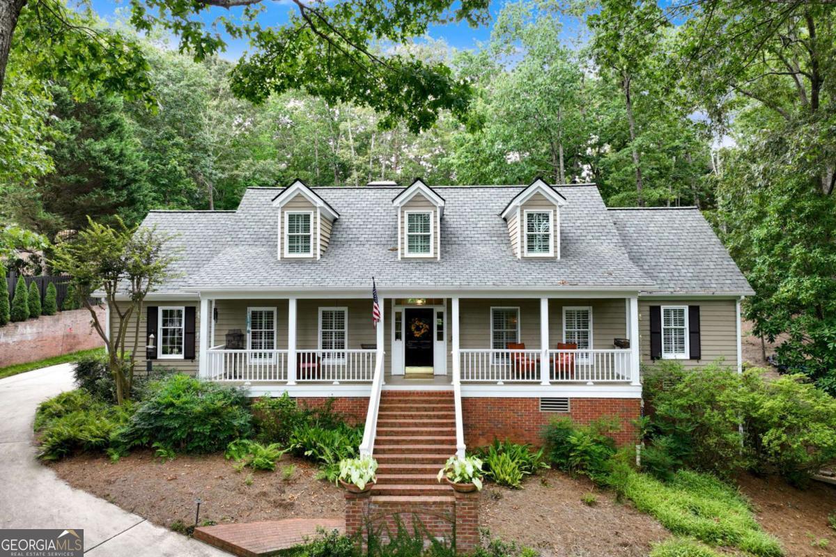From the inviting front porch to the brick patio, don't wait to discover this charming 3-bedroom, 2.5-bath home nestled in the desirable North Hall district. Surrounded by a canopy of mature trees and lush landscaping, this property offers a tranquil retreat super close to the lake. The main level offers beautiful hardwood floors, spacious kitchen, living room, dining room, handsome study, and primary suite with 2 closets. Upstairs you'll find two spacious bedrooms with shared bath and a flex room perfect for bonus room or 4th bedroom. The finished basement adds ample living space, full bath, and enough space to create the perfect in-law suite with separate entrance, while the 2-car garage offers convenience and storage. Above the garage, you'll find an unfinished space with a separate entry-perfect for a home gym, workout room, or even bonus room. The spacious lot includes an additional parcel, providing plenty of room for outdoor activities, gardening, or future expansion. This versatile home combines comfort, functionality, and privacy in a peaceful setting. Exceptional location just minutes to Chattahoochee Country Club, parks and recreation, healthcare facilities, and downtown Gainesville.
