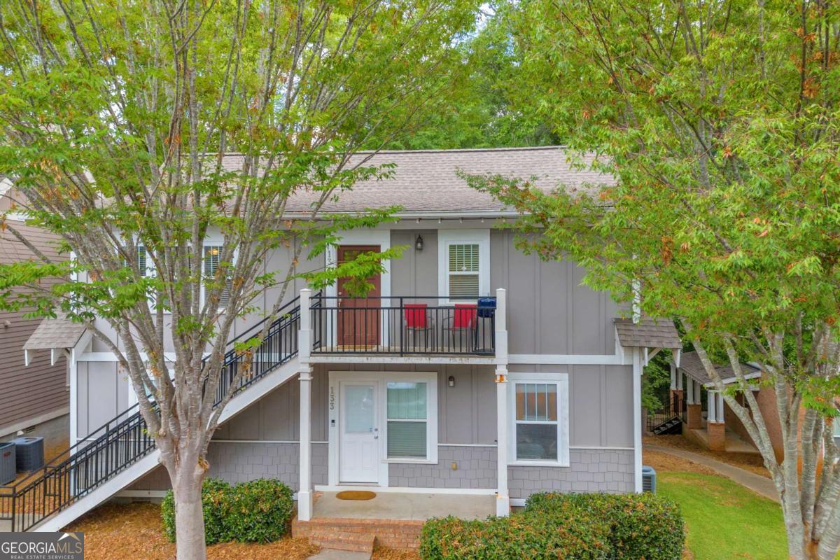 Located in the highly sought-after Woodlands of Athens, this spacious 2-bedroom, 2-bathroom condo offers the perfect blend of comfort, convenience, and investment potential. Just minutes from UGA, downtown Athens, and Loop 10, it's a prime spot for students, professionals, or anyone looking to be close to it all. This cottage-style building features one of the most desirable layouts in the community, and this unit occupies the entire upstairs, offering added privacy. Step inside to find an inviting open-concept floor plan with a bright kitchen featuring white cabinetry and bar seating, overlooking the large living area with built-in shelving. Both bedrooms are generously sized, each with walk-in closets and private access to full bathrooms-perfect for roommates or guests. Youll also love the laminate hardwood flooring throughout-no carpet! Residents of The Woodlands enjoy access to resort-style amenities, including a clubhouse, swimming pool, tennis courts, basketball and volleyball courts, and more. Don't miss this fantastic opportunity to own in one of Athens most desirable gated communities!