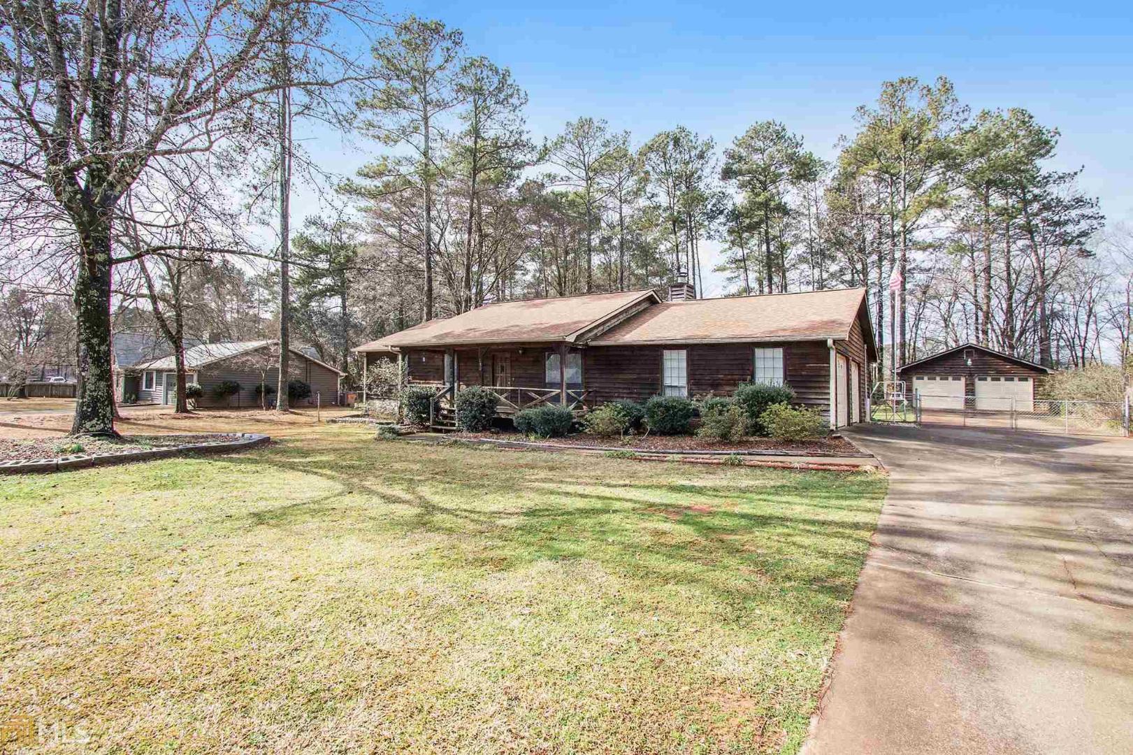 Three (3) bedrooms and two (2) bath RANCH home in convenient Stockbridge location available now with fresh new paint! Home features a rocking chair front porch, eat-in kitchen with bay window & family room w/ vaulted ceiling. The oversized family room has a beautiful stone, wood-burning fireplace. French doors open from the living area to the covered patio overlooking a large, level, private fenced backyard with a two-car detached garage/workshop. The spacious owner's suite features a walk-in closet, bathroom w/ garden tub, and a separate shower. The two-car garage has side entry and storage space. The workshop/garage has endless possibilities.