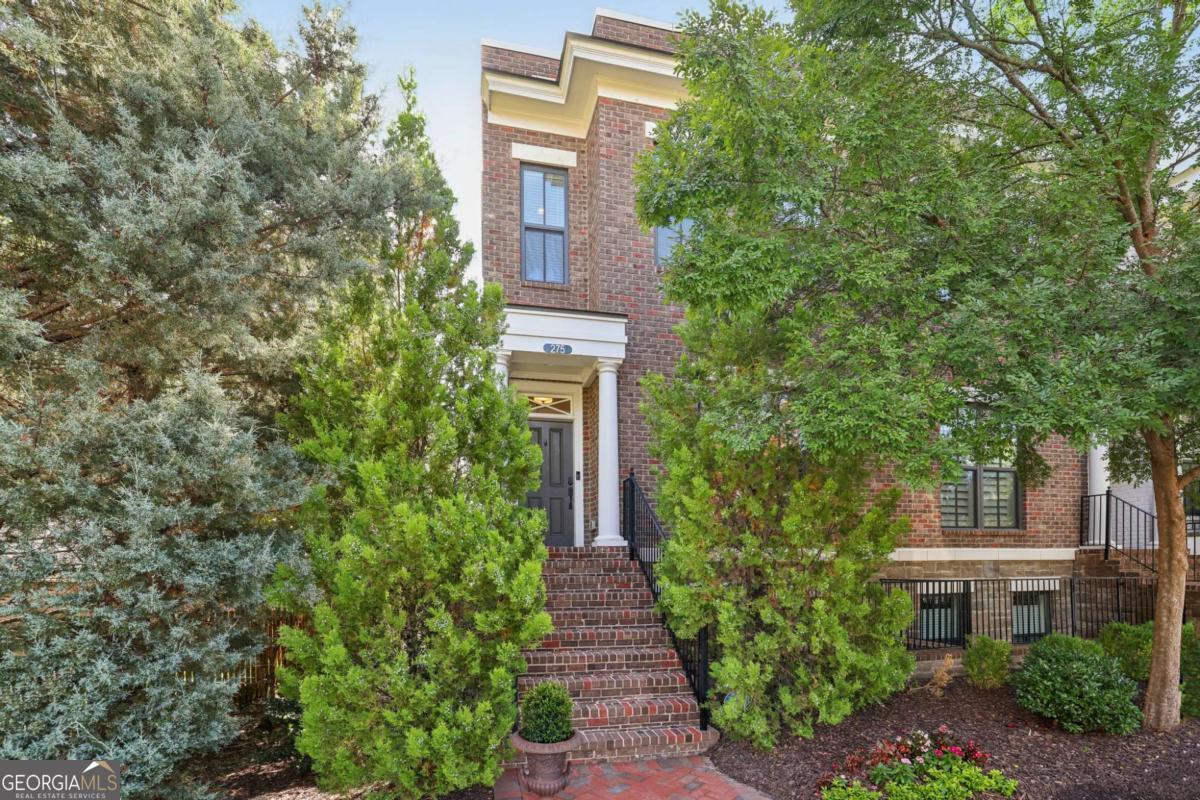 THE BEST LOCATION IN WALKABLE DOWNTOWN ALPHARETTA. Amazing End Unit in the heart of Downtown Alpharetta's City Center and Avalon!!. This amazing 3 bedroom townhome has a spacious open floorplan with shiplap detail around fireplace, hardwood floors, 10'ceilings in the living and kitchen areas and a sunroom great for an office. Kitchen has an abundance of cabinets with soft close doors/drawers, GE appliances, Large island, custom pantry and quartz counters. Large master suite w/ walk in custom closet and an enormous walk in shower with 3 shower heads. ELEVATOR READY! Extremely private location in the community backing up to spring fed fresh water 1/2 acre retention pond that is a veritable nature sanctuary. As an added Bonus this Townhome includes all of the green space to the left of the unit up to the fence. Add a side entry to the terrace level for a doggie green or a lush and green space patio to escape the summer sun for some shaded cocktails.