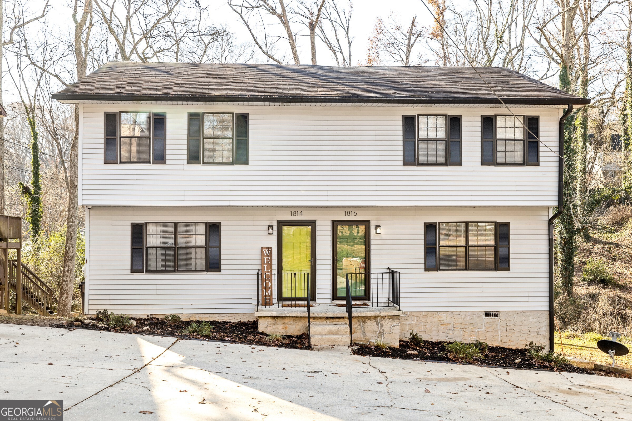 Welcome to this beautifully updated 3- bedroom, 1.5 bath townhome--one side of a well-maintained duplex--just steps from the vibrant heart of downtown East Point! The main level features durable luxury vinyl plank flooring, with carpet reserved for the bedrooms upstairs. The eat-in kitchen has been tastefully renovated with white shaker cabinets, quartz countertops and a classic subway tile backsplash. A laundry closet with washer and dryer adds everyday convenience, and the updated half bath on the main floor offers modern style and functionality. Upstairs, you'll find three comfortable bedrooms, including a spacious primary suite with a walk-in closet. The shared hall bath showcases today's finishes--trendy vanity, tile flooring, and a subway tile tub/shower combo with a built-in niche. Step outside from the kitchen onto a large deck overlooking the level backyard--perfect for relaxing or entertaining. A parking pad in the front offers space for up to three vehicles. Located just a short stroll from Downtown East Point, enjoy quick access to local eateries, the MARTA station, and lively community events. This is city living with comfort and convenience. Don't miss your chance to make this updated gem your next home-- schedule a tour today!