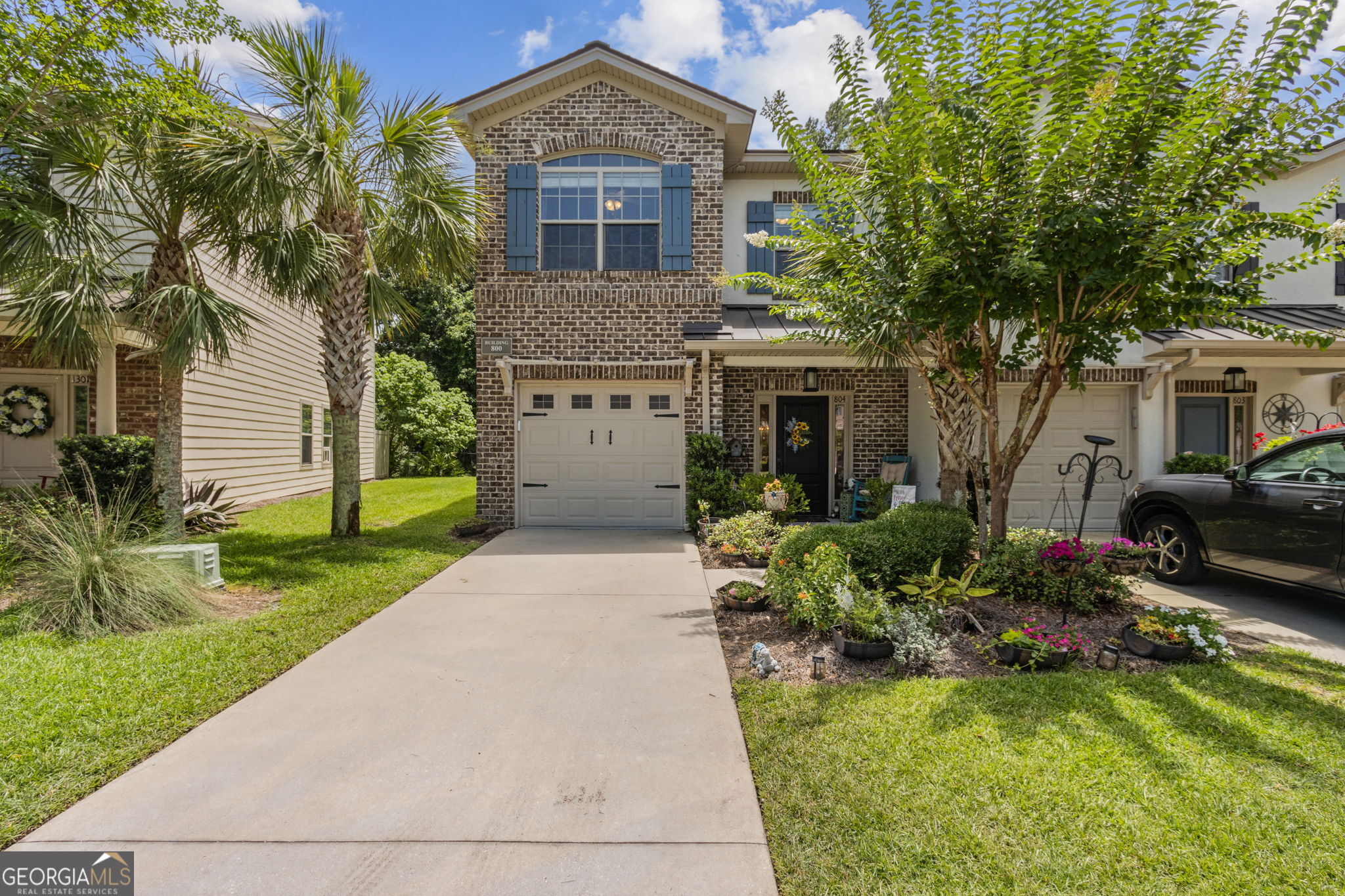 This end unit townhome in The Reserve at Demere offers a fantastic blend of comfort, style, and location-with easy access to the island's causeway and situated right along the edge of the Sea Island Golf Course Hole 4. It's less than two miles from the beach, and you'll love the light-filled living room, beautiful hardwood floors downstairs, and crown molding in most rooms. The foyer opens to handy storage closets and a powder room with a travertine counter. Throughout the home, you'll notice thoughtful details like cottage-style doors with matte black hardware. The HVAC is just two years old and includes UV light technology for cleaner indoor air. Downstairs, the open layout makes it easy to entertain, with the kitchen flowing right into the dining and living areas. The kitchen is fully equipped with stainless steel appliances, including a Bosch refrigerator and dishwasher. You'll also find a pantry, granite countertops, under-cabinet lighting, and a raised breakfast bar at the island-plus extra storage underneath and beadboard cabinet fronts that give it extra charm. Upstairs, all the bedrooms and hallway have LVP flooring (no carpet here), with tile in the bathrooms and laundry. The primary suite has a standard closet plus a large walk-in, and the attached bath features a soaking tub, separate tiled shower, double vanity with travertine counters, travertine flooring, a water closet, and lots of space to get ready. Two more bedrooms are upstairs-one with a vaulted ceiling and the other with crown molding-plus a guest bath and a laundry room with cabinets for storage. Out back, enjoy a peek at the golf course from your open patio, or take advantage of the roomy side yard. There's also an attached one-car garage with automatic opener and keypad. Bonus: the living room TV and one bedroom TV will stay with the home. And if you're looking for a place with low maintenance and high convenience, you'll love that the community pool is just steps away and no flood insurance is required. This home makes a great full-time residence, seasonal escape, or rental investment-especially for FLETC folks-just minutes from Saint Simons Island's beaches, restaurants, and shops. Easy living with easy access on and off the island.