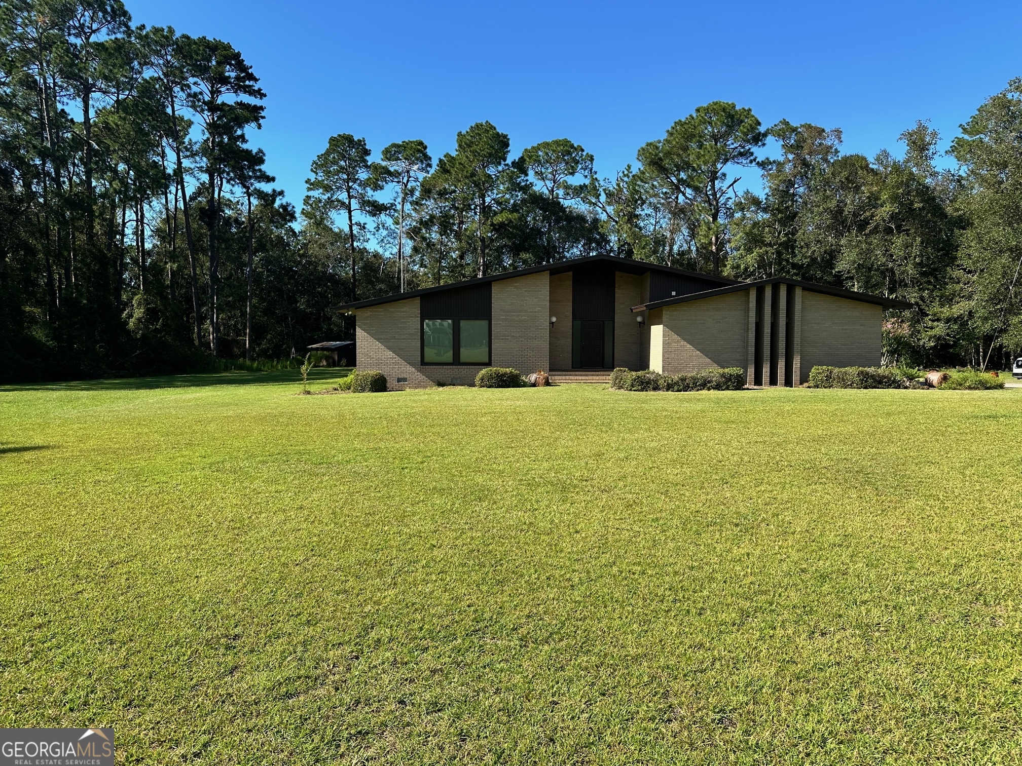 Beautiful 3 Bedroom 2.5 Bath in the heart of Nevil. City Sewer and Water. Large 3.74 Acre Lot with shop and electricity to the shop. Home is custom built in the 70s and in excellent condition. Tankless Water Tank. 2 Car Carport. Nevil and South East Bulloch School District. Enclosed glass sunroom.