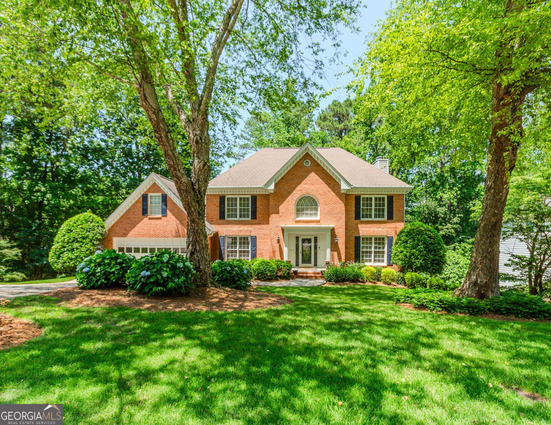 Welcome to this stunning two-story home, nestled in a private cul-de-sac in the sought-after Buckingham Subdivision. Set on a beautifully landscaped, parklike lot, this property offers both charm and functionality throughout. Step into a grand foyer that flows into an oversized dining room perfect for hosting. The spacious kitchen boasts white cabinetry, a rich stained island, double ovens, upgraded appliances, and a generous breakfast area overlooking the serene backyard. The inviting family room features a cozy brick fireplace and plenty of natural light. Upstairs, you'll find a luxurious master suite complete with a trey ceiling, French doors, and a spa-inspired master bath featuring double vanities, a separate shower, a garden tub, and a large walk-in closet. Three additional guest bedrooms, an updated full bath, and a versatile bonus room ideal for a home office, gym, or playroom complete the upper level. The finished terrace level is an entertainer's dream, offering hardwood floors, a media room, recreation room, fitness space, and a private study with custom built-ins and a second fireplace. Enjoy outdoor living with a spacious deck and poured patio perfect for relaxing or entertaining. This home also includes a two-car garage and is located in the highly desirable Collins Hill school cluster, just minutes from Collins Hill High, parks, shopping, the Mall of Georgia, Coolray Field, and major highways.