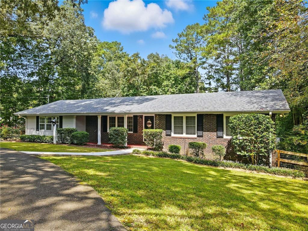 Charming, Updated Retreat Near Downtown Canton & The Mill at Etowah Welcome to 123 Dorsey Road, a beautifully updated home nestled on a large, private lot just minutes from vibrant downtown Canton and the popular Mill at Etowah. Located in a highly sought-after school district, this property offers the perfect balance of convenience, turn-key comfort, and privacy. Set back from the road and surrounded by lush, mature landscaping, this home boasts gorgeous curb appeal and a peaceful, fenced backyard oasis - complete with an outbuilding and plenty of space to roam, relax, or entertain. Inside, you'll find thoughtful updates throughout, including stylish finishes, modern fixtures, and a newer roof (2020). The spacious layout features two separate living rooms, offering flexible spaces for gatherings, a playroom, or a home office. The bright kitchen overlooks the living and dining areas, creating a welcoming flow for everyday living and hosting. Not to mention the gorgeous views of the meticulously maintained backyard from the kitchen and the dining room! The primary suite is a true retreat, offering generous space and a beautifully updated ensuite bathroom. Two additional roomy bedrooms share a well-appointed full hallway bath, making this home as functional as it is beautiful. Step outside to a back deck overlooking the expansive, manicured backyard - ideal for morning coffee, weekend barbecues, or simply enjoying the quiet surroundings. Don't miss your chance to own this move-in ready gem in one of Canton's most desirable locations. 123 Dorsey Road combines location, layout, and lifestyle - all in one exceptional property.