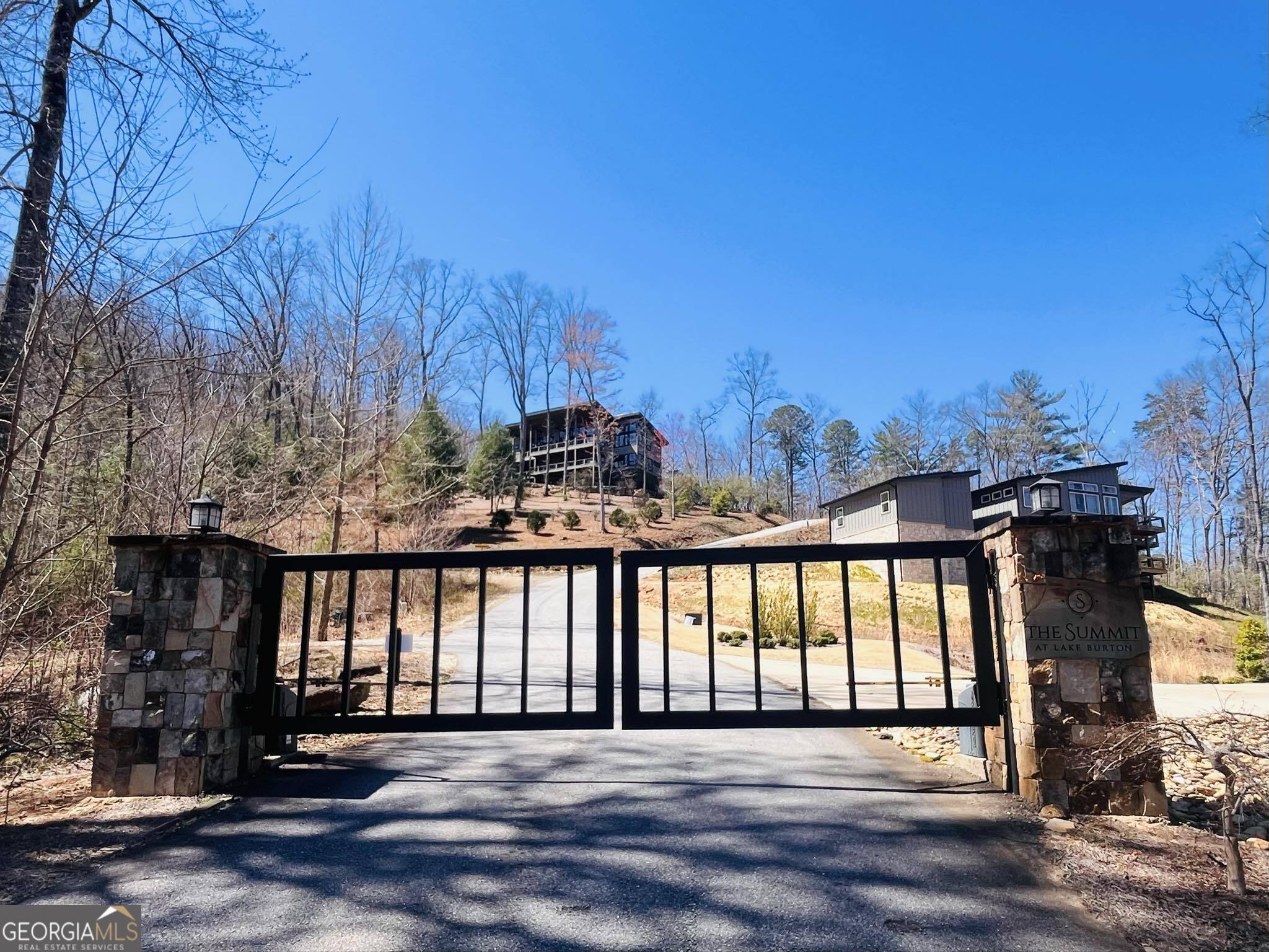 Build your dream home at "The Summit at Lake Burton," an upscale gated community across from the prestigious Lake Burton! A bonus to this lot is a creek with a cascading waterfall flows gently along the left property line! Seasonal views can be opened up with some tree clearing. This is a prime location as LaPrades Marina and Restaurant is within 2 miles and another boat launch at the Fish Hatchery about a mile away. You'll have access to a wealth of recreational opportunities right at your doorstep. Whether it's boating, fishing, hiking or just unwinding in the peaceful serene privacy of your mountain home! The property is convenient to The Waterfall Club and the quaint shops and restaurants of Clayton. With several homes already built in this community and more in the process you won't want to miss out! BONUS this is a FEE SIMPLE lot and SHORT TERM RENTALS are allowed! Build your dream vacation home and rent it out when you're not there! Lot 50 beside it is also available. Per Covenants if someone buys both lots, Association fee is only $500 Not $500 per lot.
