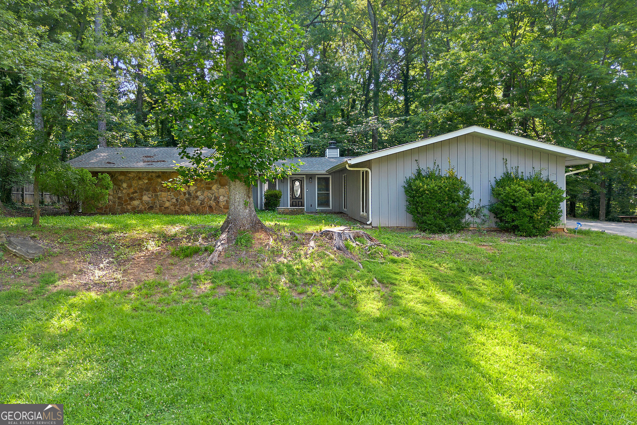 Now Offering 0% Down Financing + 5% Fixed Interest Rate with Preferred Lender! Welcome to this charming classic ranch home, ideally located in one of Stone Mountain's most desirable and peaceful neighborhoods. Surrounded by friendly neighbors and set on a large, private lot, this home offers both tranquility and a true sense of community. Inside, you'll find an abundance of natural light streaming through large windows and skylights, creating a warm and airy atmosphere throughout the home. The open layout in the main living areas gives a full, spacious feeling that makes the home perfect for both everyday living and entertaining. The large kitchen is a standout feature, complete with stainless steel appliances and plenty of space to cook and gather. In addition to the main living space, the garage has been thoughtfully converted into a bonus area that adds valuable, livable square footage, including two separate storage rooms ideal for a home office, gym, or creative studio. This home combines classic charm with modern comfort in a location that's hard to beat. Seller is motivated!