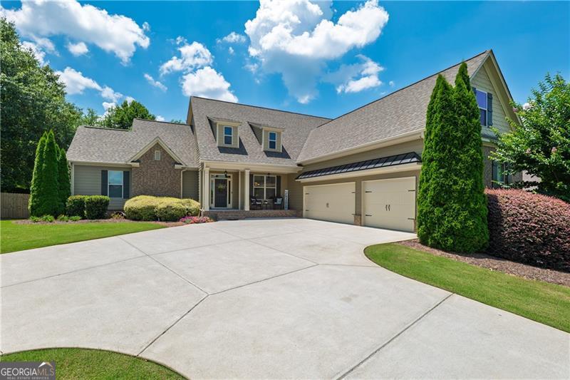 Welcome Home to this Craftsman style home located in a cul-de-sac in the Bradshaw Glen neighborhood. The exclusive community has 31 homes next to Bradshaw Farms Golf Club, is close to the Hickory Flat/Canton area, shopping, restaurants and downtown Woodstock is just minutes away. This 5 bedroom/4.5 bath home features the primary bedroom on the main as well as an additional bedroom/office on the main and 3 additional bedrooms on the upper level with 2 full baths. The open floor plan provides a great entertaining atmosphere with an open kitchen to the family room featuring a fireplace with built in bookcases and easy access to a covered porch with an outdoor fireplace overlooking your private oasis. The finished terrace level features a kitchen area, gaming room, theater room, fitness room, office nook, a full bath and ample storage space. Walking out from the terrace level you will find resort style living with a private pool, a fenced in yard, & manicured mature landscaping. An extra bonus feature of the home is the level driveway/extra parking area and a spacious 3 car garage! The home has been well maintained, recently painted inside and is move-in ready. This pristine home is also located in a top rated school district. Perfect timing to get settled before the new school year begins.