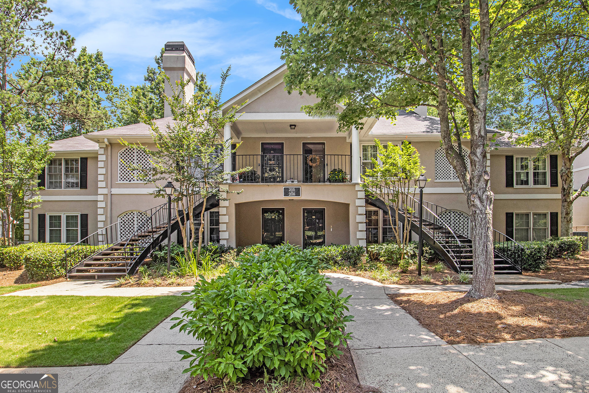 Ground-level, stepless-entry, single-level condo featuring 2 bedrooms and 2 baths-just minutes from The Forum, Historic Norcross, and within walking distance to the Premium LifeTime Club and Triangle Park, all while offering the peaceful feel of a wooded retreat! A welcoming foyer leads into a fireside great room that opens to an enclosed patio with serene views of mature landscaping. The spacious dining area flows into a well-appointed kitchen with ample cabinet and counter space. A separate laundry room is conveniently located just off the kitchen. The primary suite includes its own private bath with a double vanity, soaking tub and walk-in closet. The second bath has been upgraded with a stepless shower and both bathrooms feature upgraded countertops. Two refrigerators, a washer, and a dryer are included in the sale. Peachtree Forest Plantation is a charming, quiet community of just 80 units. HOA dues cover water, trash, pool access, exterior building maintenance, well-lit walkways, guest parking, and beautifully maintained landscaping. Love to dine out or shop? You're only 2 miles from the vibrant Peachtree Corners Town Center and The Forum!