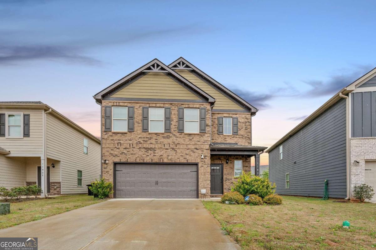 Welcome to your luxurious retreat in Hampton, GA! This exquisite 4-bedroom, 3.5-bathroom home offers unparalleled comfort and style, with thoughtful design elements throughout. As you enter, you're greeted by a grand 2-story foyer, setting the tone for the elegance that awaits within. The heart of the home is the stunning kitchen, featuring a gorgeous large island with bar seating for four, ideal for both casual dining and entertaining guests. This space is enhanced by stylish starburst pendants over the kitchen bar, complementing the sleek Samsung stainless steel French door refrigerator and modern bronze bathroom hardware found throughout the home. The main floor features a secondary master or in-law suite, complete with its own ensuite and walk-in closet. Upstairs, the HUGE primary bedroom suite awaits, boasting a spacious layout and a lavish ensuite bathroom with a double vanity, separate soaking tub, and shower. Alongside the primary suite, you'll find a versatile loft space, perfect for relaxation or entertainment, as well as two additional bedrooms and a full bathroom. Additional upgrades include contemporary ceiling fans, Samsung full-size washer and dryer included for added convenience, and blinds throughout, ensuring privacy and comfort. With its unique features, including the sought-after sold-out Millhaven floorplan, this home offers the perfect blend of functionality and comfort.