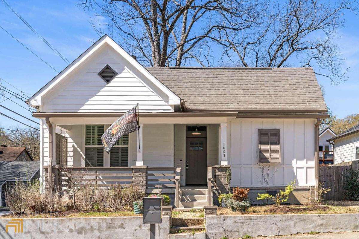 Must see opportunity in Historic Pittsburgh located just 2 blocks from the Westside BeltLine and Pittsburgh Yards. This well-maintained farmhouse has been renovated from the ground up maximizing the historic charm of the home while blending it with modern functionality. The welcoming and spacious entry hall beautifully connects the living spaces with the sleeping spaces showcasing the soaring high ceilings and hardwood floors running throughout the home. An entertainer's dream, this home boasts dedicated space indoors and outdoors for hosting the ultimate gatherings with friends and family. The chef of the home will love the oversized kitchen with top-of-the-line Stainless Steel appliances, floor to ceiling storage, farm sink and granite countertops, and separate bar with beverage refrigerator. Centered in the home, the historic double fireplace facing both the kitchen and living room adds a feeling of warmth and comfort grounding the family room and mirroring the height of the breathtaking cathedral ceiling. Sneak into your primary oasis with large custom closet and beautiful en-suite bath complete with rain shower and double vanity. Two additional roomy bedrooms with custom closets share a bright bathroom with extra deep tub for soaking. Shaded by two amazing old pecan trees, your new private backyard is built for slow weekends with friends. With a gravel patio perfect for outdoor dining and firepit for roasting marshmallows, youCOll have trouble getting your guests to leave! Wave good-bye to friends and family from your large covered rocking chair front porch. With off-street parking for 2, private gated yard with separate fenced storage or dog run along and privacy shutters on the home, no detail has been overlooked. Conveniently located in Historic Pittsburgh, this home provides easy access to I-85, downtown Atlanta and the West Side BeltLine. Enjoy neighborhood favorites like Pittsburgh Yards, Perkerson Park, Rodney Scott BBQ and The Met. Welcome Home.