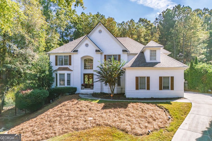 Elegantly tucked at the base of a picturesque cul-de-sac, this exquisite residence is perfectly positioned on a prime 1/2-acre lot in the heart of Sandy Springs, GA. A warm, light-filled interior welcomes you upon entry, setting the tone for refined living and effortless comfort.  The main level showcases a true open-concept design, ideal for both grand entertaining and relaxed everyday living. At its center lies a chic, beautifully updated kitchen that flows seamlessly into the surrounding living spaces. A spacious office/bedroom on the first floor, situated adjacent to a full bath, offers exceptional flexibility-whether as a private home office, guest suite, or serene retreat.  Upstairs, the expansive primary suite features a luxuriously updated bathroom and generous closet space, creating a peaceful haven. Three additional bedrooms are bright, airy, and thoughtfully proportioned, providing comfort and style for family or guests.  The home also offers a large basement with abundant storage and framing already in place-an excellent opportunity to customize and expand. Just off the two-car garage, a well-designed drop zone provides a convenient and organized space for coats, bags, and everyday essentials.  Perfectly situated in a coveted Sandy Springs location near Dunwoody, this home offers exceptional access to top-rated schools, premier grocery stores, and an array of acclaimed restaurants-bringing both convenience and lifestyle to your doorstep.