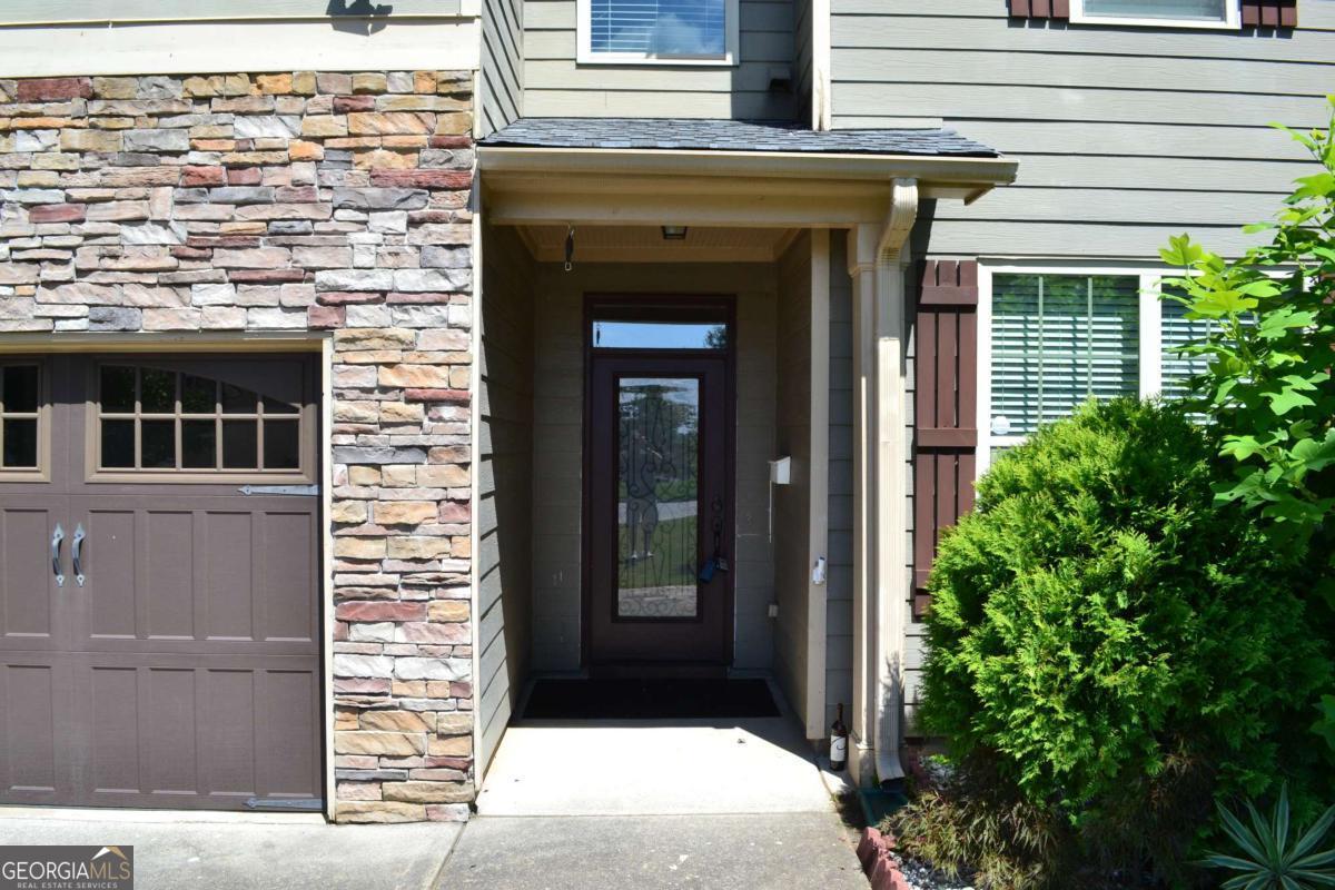 Great home in Lambert HS. Swim and tennis community. Hardwood throughout. Sunroom.