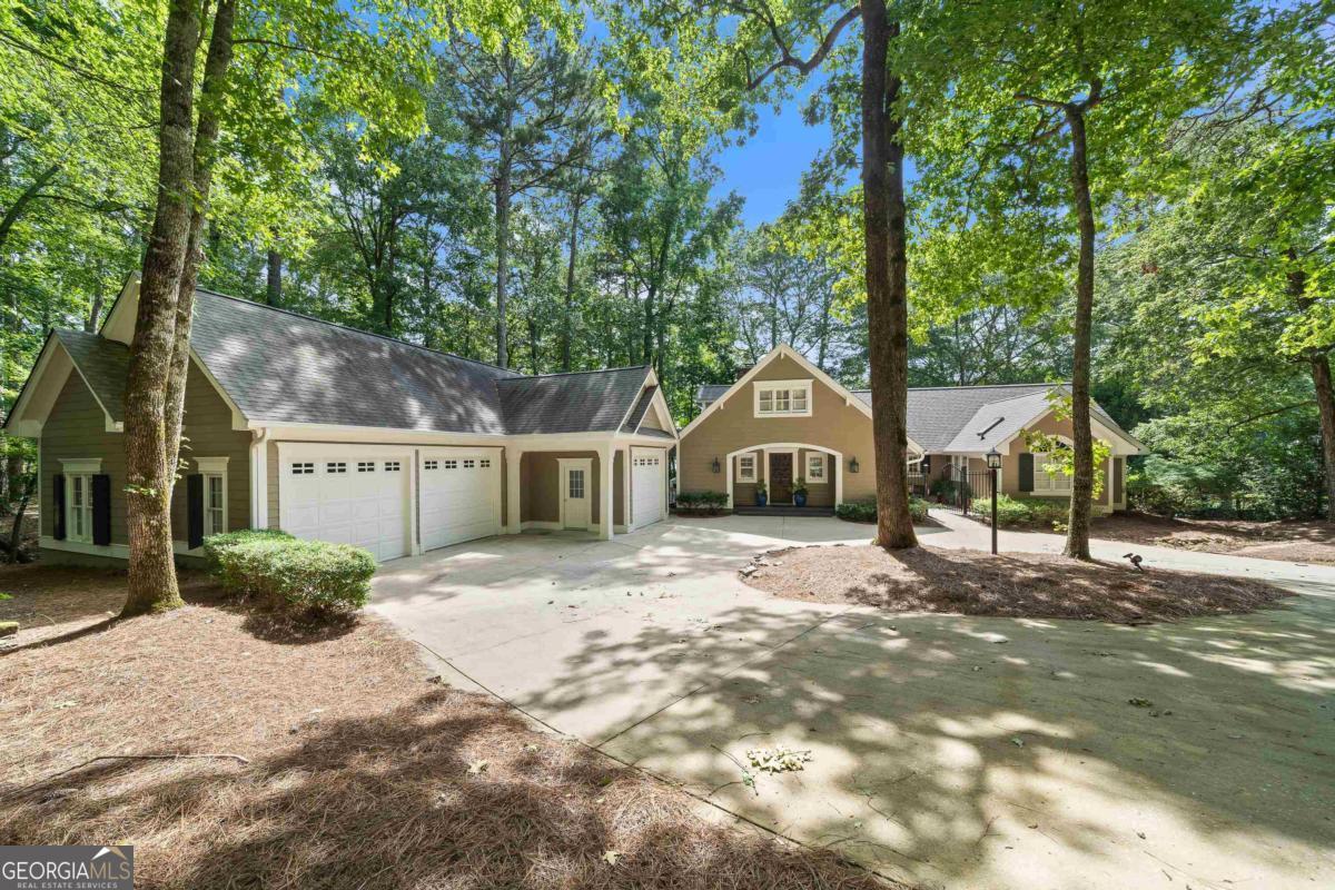 Charming Lakefront Cottage in Reynolds Lake Oconee Discover the charm and character of this inviting lakefront cottage centrally located on Lake Oconee. Thoughtful floor plan with cozy, rustic architecture and warm natural finishes, this five-bedroom, five-bath home offers the perfect blend of comfort and style for lake living at its best. Enjoy long views of the lake from the screened porch or relax on the open deck as you take in the stunning sunsets. Inside, the home features a welcoming layout with room for family and guests, all centered around the tranquil beauty of lake living. A rare find, the property also includes a three-car garage-perfect for extra storage or lake toys. Whether you're entertaining, relaxing, or exploring all that Reynolds has to offer, this home is a true lakeside retreat with timeless appeal. Seller is making a membership available.