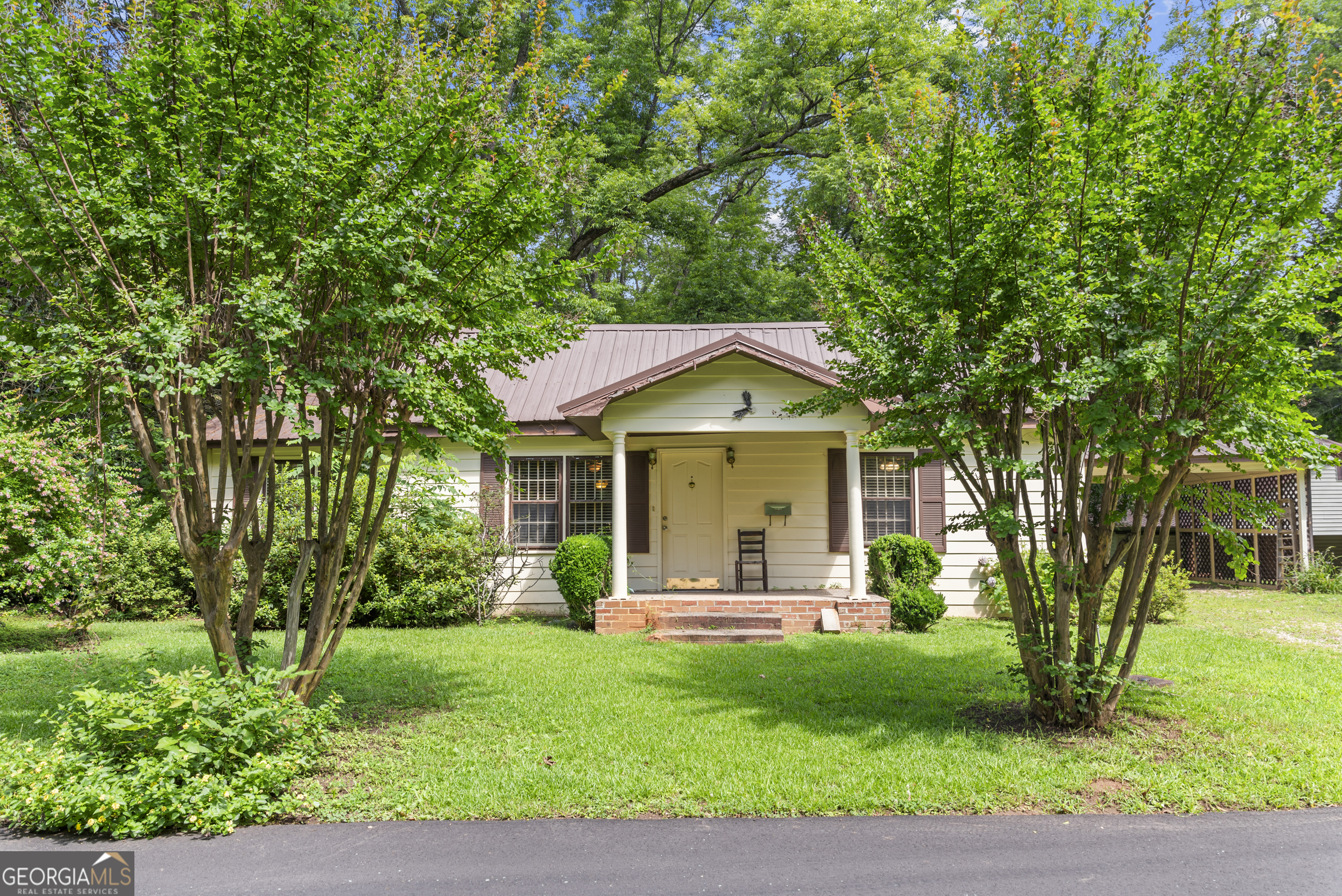 For the first time ever, these four contiguous parcels-including two homes and two buildable lots-are being offered together, presenting endless possibilities for preservation, development, or a private in-town estate. This sweet cottage features 3 bedrooms, 1 bathroom, a spacious eat-in kitchen, a screened porch and laundry room. Both homes reflect the timeless character Madison is known for, offering classic Southern architecture with welcoming front porches, original details, and mature landscaping. There are two additional lots, ideal for future homes, gardens, guest cottages, or simply to enjoy added privacy and green space. Nestled on a quiet, tree-lined street, they blend seamlessly into the historic surroundings. Walking distance to downtown shops, dining, and cultural landmarks. Preserve history, build the future, or create your own legacy-right here in Madison's iconic Historic District.
