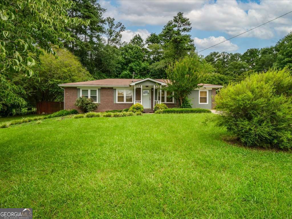 Welcome to one of the most beloved neighborhoods in town, where long-time owners stay for decades and newcomers quickly feel at home. This classic all-brick ranch sits on nearly half an acre, giving you the space and privacy everyone wants but rarely finds. The level, fenced backyard is perfect for summer barbecues, games of catch, or unwinding on the patio with friends. Out front, the covered porch is made for slow mornings with coffee in hand. You will also find a large, well-maintained shed out back, ideal for storage, hobbies, or a future workshop. Step inside to an oversized living room with gleaming hardwood floors that flow throughout. The renovated kitchen (2019) is a standout, featuring granite countertops, stainless steel appliances, and rich cherry cabinets that make cooking feel like a treat. The primary suite offers a rare bonus for the neighborhood: a walk-in closet and private half bath. Two spacious secondary bedrooms share a hall bath accented with timeless beadboard. This is a home with character, thoughtful updates, and plenty of extras to enjoy.