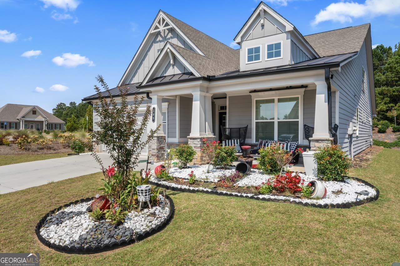 Welcome to this elegant Fayetteville home offering a spacious and thoughtful floor plan with the primary suite on the main level. Step into the impressive foyer that opens to a formal dining room, accented by soaring two-story windows, creating a bright and inviting space. The gourmet kitchen features white stone countertops, an oversized island with a farmhouse sink, gold hardware, a five-burner cooktop, and stainless steel appliances (Samsung refrigerator and Frigidaire suite included). A cozy den with tray ceiling and accent walls offers a stylish place to relax, complete with recessed lighting. The primary suite boasts a sitting area, skylight, private access to the covered patio, double vanities, a tiled walk-in shower, and a large closet with direct access to the laundry room. An additional bedroom and full bath are located on the main level for convenience. Upstairs you'll find a spacious loft, an additional bedroom with semi walk-in closet, full bath, linen closet, and dedicated media area. Outdoor living is a true highlight with a glamorous extended covered patio featuring a ceiling fan and slatted wood privacy accents-perfect for year-round enjoyment. Despite its convenient location, the backyard feels private and serene. This home combines elegance and function in every detail-schedule your showing today!