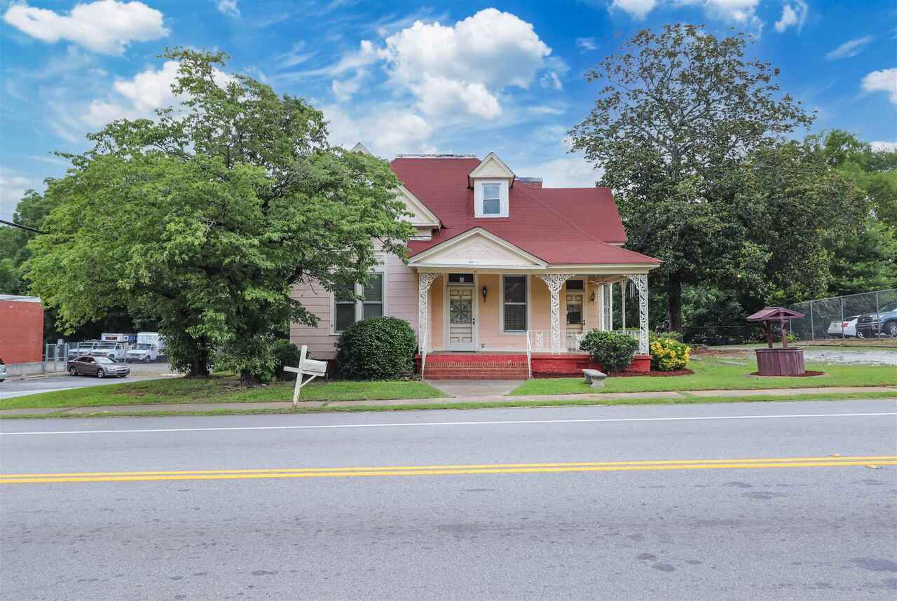 GREAT THINGS ARE HAPPENING IN FAIRBURN! Here is your opportunity to own a piece of history with this beautiful, updated, historic home built in 1901 and listed well below appraised value! Featuring 4 bedrooms, 2 full baths, formal dining room, kitchen, living room, anteroom, all with original hardwood floors! Original molding, wainscoting, coal fireplaces, and a beautiful wraparound front porch with iron railings. This home is zoned DTMU (Downtown Mixed Use) and affords the opportunity to have a small business on the main level if you choose while having your residence upstairs. Ample parking and a large fenced in backyard complete this gorgeous home.