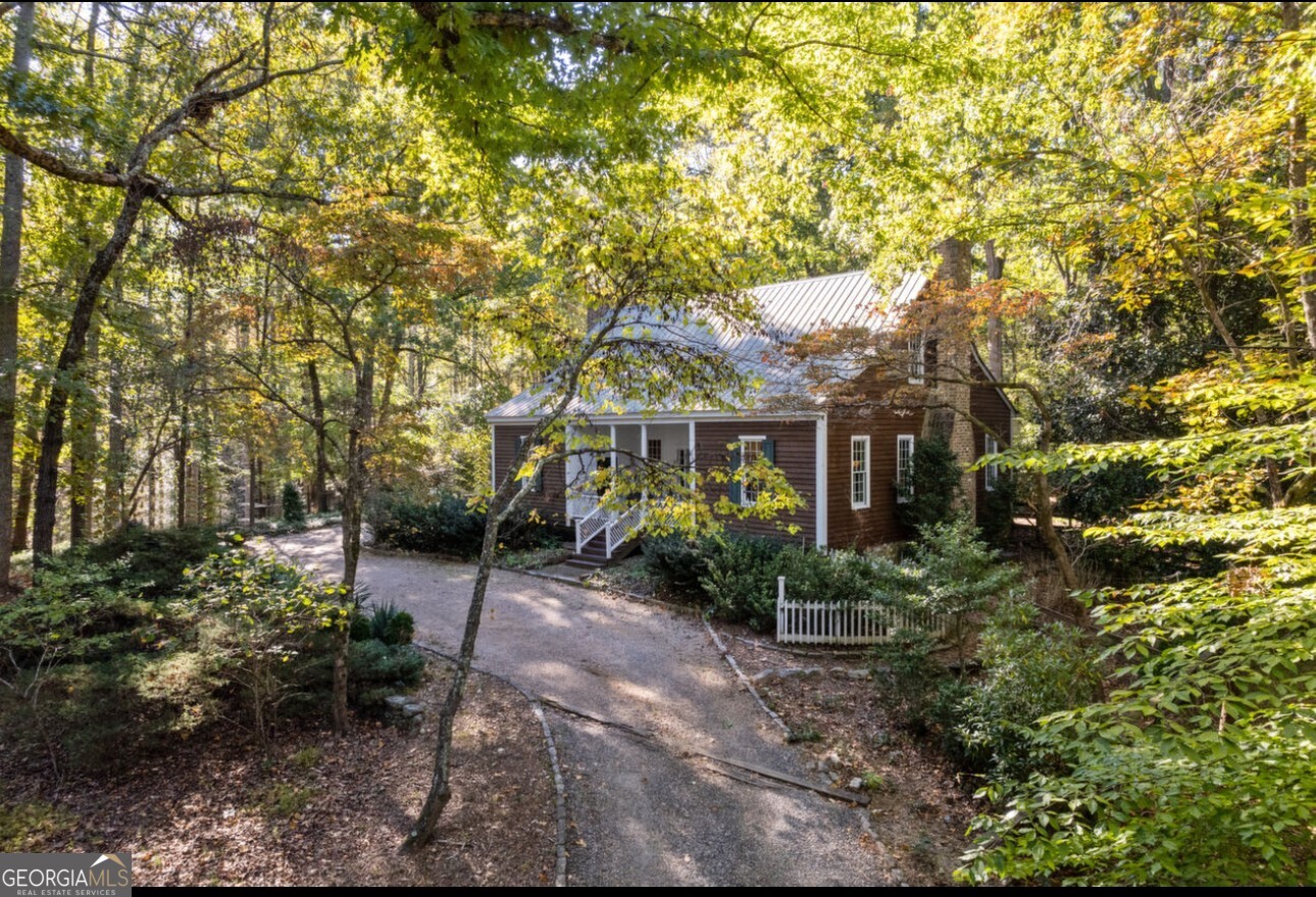 A rare and unique find. 23.165 acres, four houses, two are rented below market for combined $2,650.00 per month with a thrid home(LogCabin with modern amenities). Main Home is a rebuilt, an authentic farm home.Designed farm home by Farmed Georgia Classical architect James Means. Reconstructed on this propety and sits at 13250.