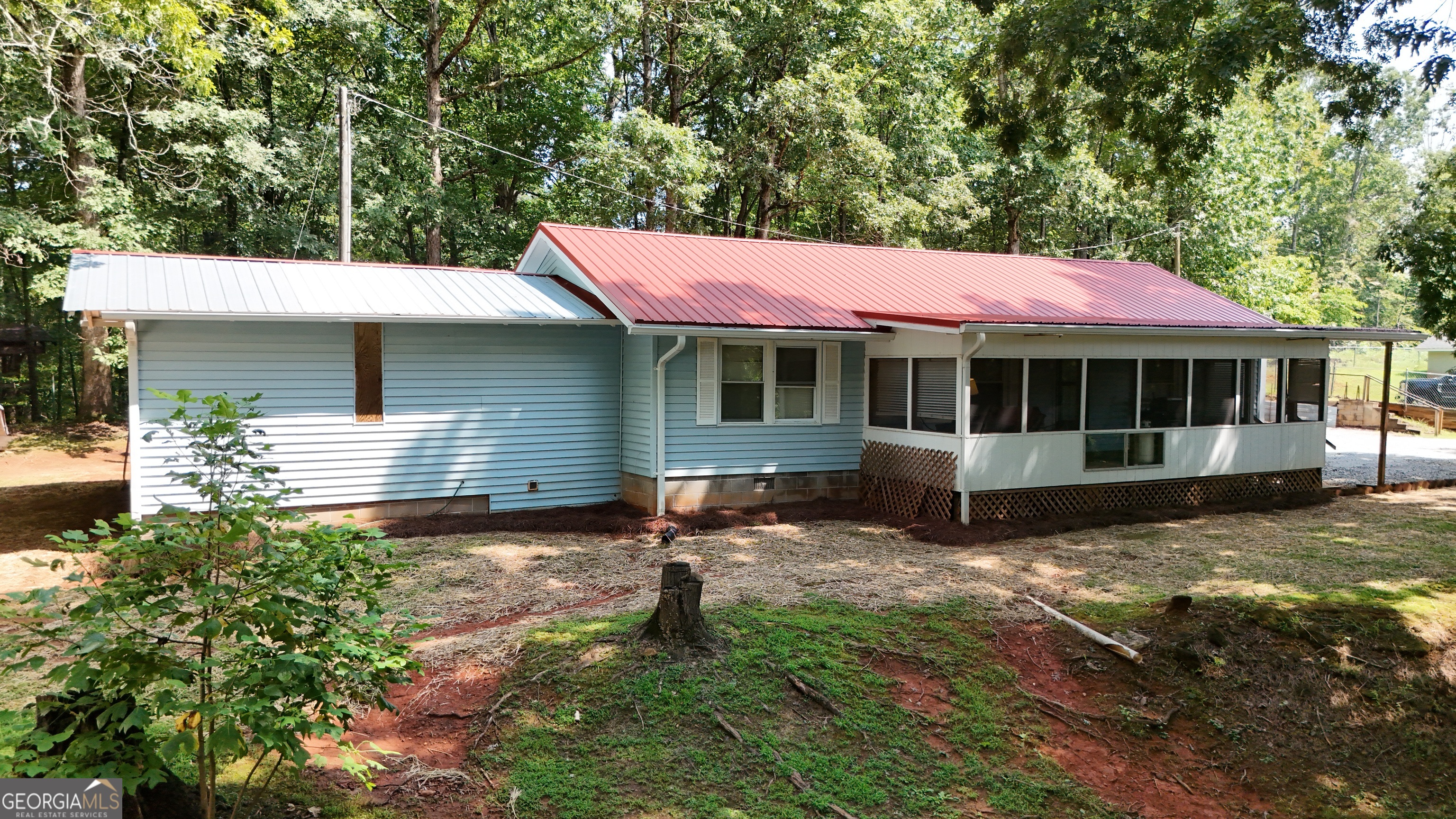 Charming 3-Bedroom Home on 1.05 Acres - Ideal Starter or Downsizer! Welcome to this inviting 3-bedroom, 2-bath home situated on a 1.05-acre lot. Whether you're looking for your first home or planning to downsize, this property offers comfort, convenience, and room to grow. You'll love the spacious front yard-ideal for kids, pets, or gardening. Inside, the main living area features easy-care laminate flooring, while the well-designed kitchen boasts ample cabinetry and flows seamlessly into the dining area. Upgraded windows throughout the house. A laundry room is conveniently located just off the kitchen for added ease. Enjoy the changing seasons from your screened-in front porch-perfect for relaxing year-round. You will appreciate the extra square footage the bonus room adds that was built onto the home. The property also includes a 14x26 garage, a lean-to, and a out building for all your tools and toys. The fruit tree's add a great touch to the yard! Located just minutes from schools, restaurants, shopping, and the charming town of Helen, this home offers the best of both comfort and convenience. Don't miss this great opportunity! ***HVAC unit only 1 month old...practically new!***
