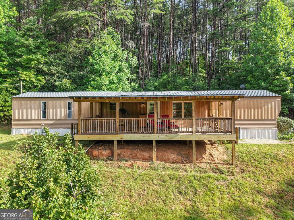 SELLER FINANCING AVAILABLE! Enjoy breathtaking mountain and lake views from this move-in ready 2-bedroom, 2-bathroom home, perfectly situated on 1.5 acres with no HOA. Just five minutes from downtown Blue Ridge, this property offers the ideal blend of privacy, scenery, and convenience. Built on a permanent foundation, the home features 925 sq ft of inviting living space. The kitchen has been upgraded with new stainless steel appliances-including a dishwasher, refrigerator, and gas stove-along with a newer dryer. From the front deck, take in panoramic views that make every morning and evening special. The property also includes a spacious workshop barn ideal for hobbies or storage, plus a charming chicken coop ready for your backyard flock. Whether you're looking for a family home, a serene retreat, or a short-term rental investment, this home delivers comfort, natural beauty, and unbeatable proximity to Blue Ridge shopping, dining, and attractions.