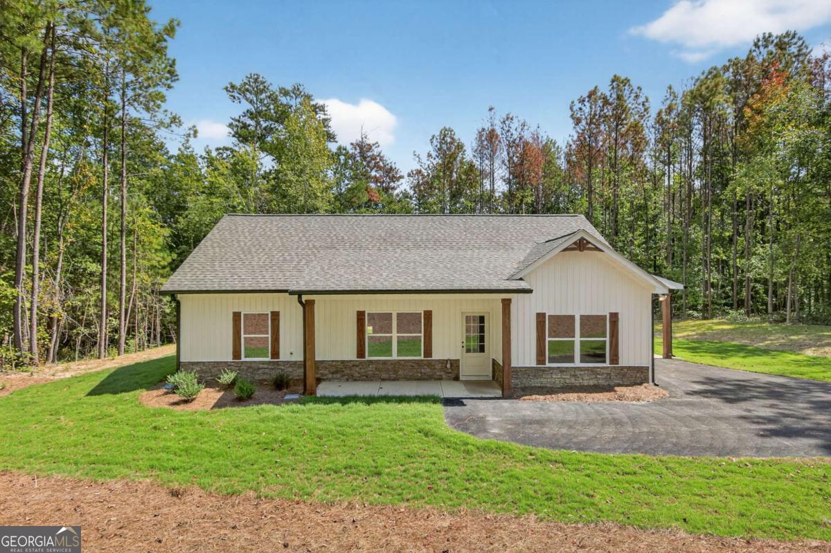 Construction is COMPLETED! Do not miss your chance to own a 0.75-acre lot with NO HOA! This gorgeous step-less RANCH home boasts an open-concept design with a spacious VAULTED family room. The gourmet kitchen features GRANITE countertops, a FARMHOUSE SINK, a large PANTRY, and stainless steel appliances, perfect for entertaining. The large master suite offers a private retreat with a beautiful ensuite bathroom featuring a double vanity, custom TILE SHOWER & a generous walk-in closet. Two generously sized secondary bedrooms offer ample storage space with large closets, complemented by a stylish full bathroom. Step outside to the covered back patio for your morning coffee, or relax on the rocking chair front porch. The CARPORT is an added convenience for all of your outdoor needs. Standard features include beautiful luxury LVP in the kitchen, living room, entry, and baths; plush carpeting in the bedrooms; and high-quality finishes throughout. Enjoy the freedom of a PRIVATE LOT with no HOA restrictions, combining tranquility with convenient access. Minutes to Rockmart, Dallas, & Hiram! Please be sure to ask about our incentives, using the seller's approved lender, Gareth Thomas, with Silverton Mortgage. Not quite the right floor plan? We have other options & LOTS available! Contact us today for further details!