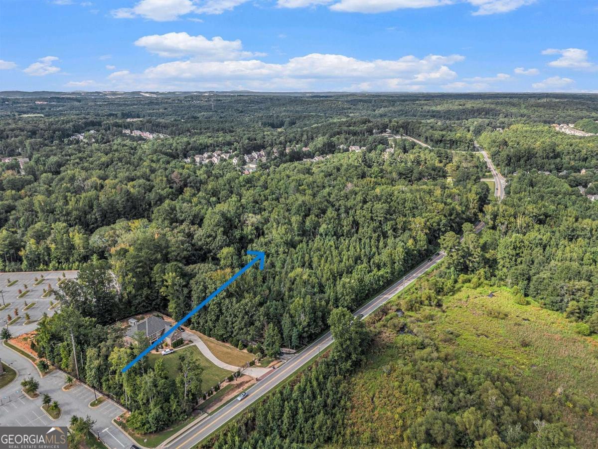 3.8-acre wooded lot with versatile potential. Zoned Sub-C (Suburban Commercial), the property allows for residential, office, or select commercial uses. An older home sits on the property (do not enter), offering the option to rebuild or redevelop. Minutes from Wolf Creek Country Club, Camp Creek Marketplace, major highways, Downtown Atlanta, and Hartsfield-Jackson Airport. Whether you're envisioning a custom estate, multiple home sites, a professional office, or a community-serving institution, this property provides the canvas. Its Sub-C zoning delivers the kind of flexibility rarely found in today's market.