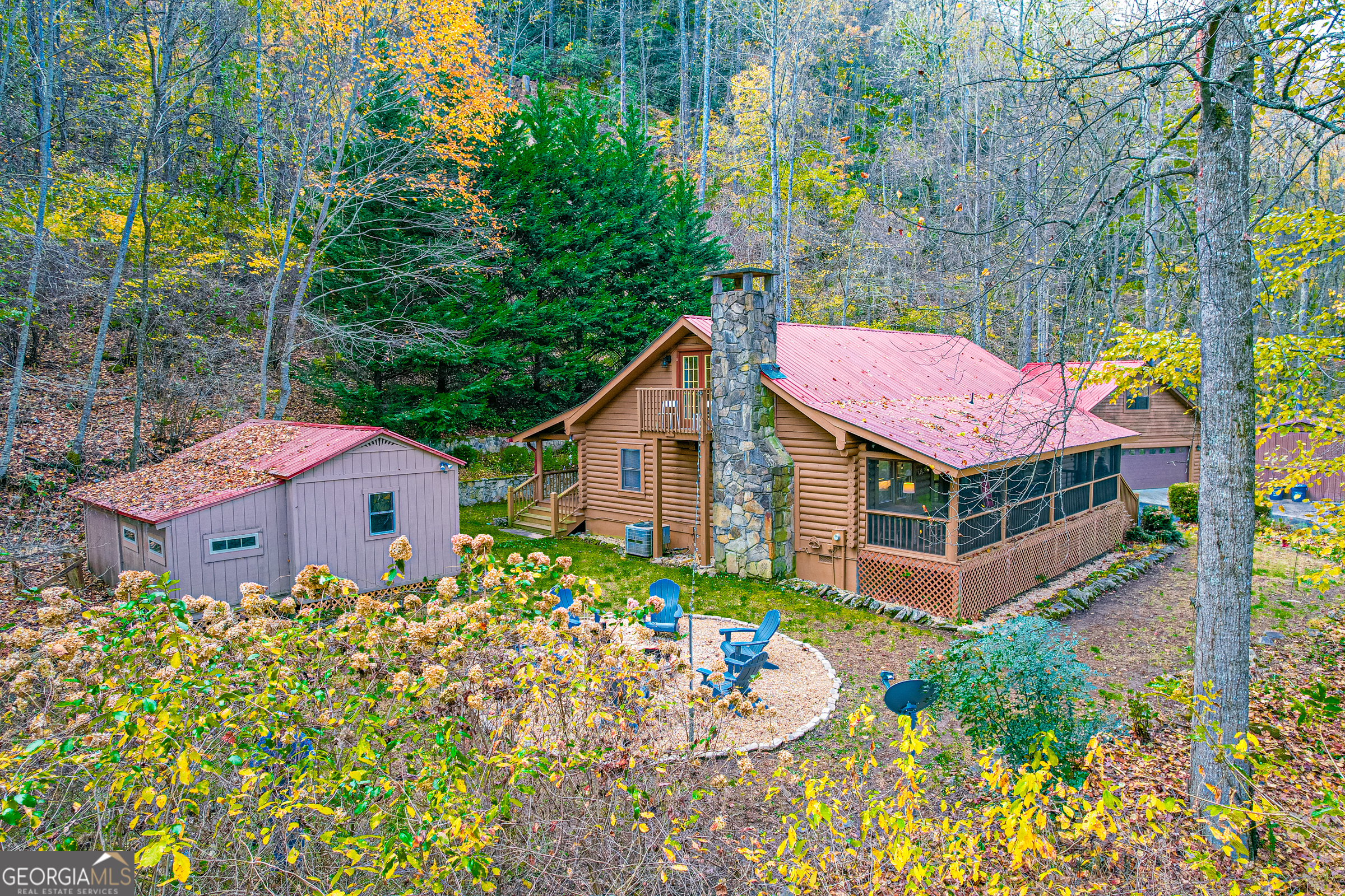 FULLY FURNISHED QUINTESSENTIAL MOUNTAIN LOG CABIN! Nestled up high on beautiful Chestnut Mountain. 4 bedroom 3 bath home oozing with charm. TRUE LOG CABIN - Beautiful hardwood floors, beamed walls/ceiling and specialty lighting steals your heart as you feel the true mountain experience. Great full time living or spectacular vacay home! 1.24 acres - lots of spread-out space. Full screened front porch overlooking thick hardwood forest - seasonal mountain views. Rear porch also spans the home and offers 100% privacy. Primary suite on main - secondary bedroom on main with additional full bath. Laundry on main. 2 bedrooms and one full bath upstairs. Hardwood flooring throughout. Incredibly cozy fireplace in family room - Super generous/beautiful granite kitchen with cabinet space and counter space galore. Detached quality 2 car garage with finished game room/billiard room above. Additional separate RV garage to house your RV and toys. This cabin can convey completely furnished and comfortably SLEEPS 10 PEOPLE. All beds are EXTRA COMFY. Quality furnishings. Just bring your toothbrush! This home offers the most comfortable and fun way to bring all your favorite peeps under one roof with lots of space for all! Paved roads all the way to the cabin. Agent/Owner. Good rental history.