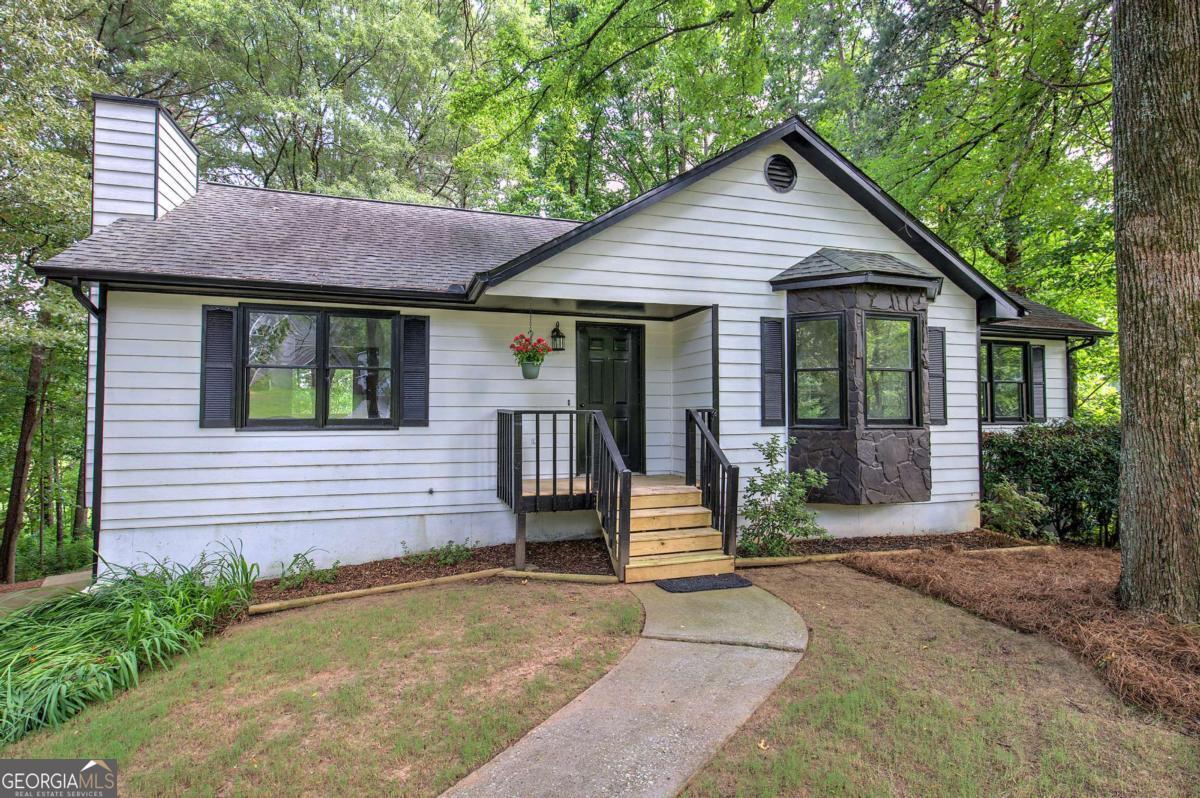 Welcome home to 17 W. Ridge Dr. SE! This charming ranch over a basement is situated on over a half-acre lot just minutes from downtown Cartersville, I-75, and the Bartow County boat ramp at Lake Allatoona. The inviting living room features smooth ceilings and a beautiful stone fireplace, creating a cozy atmosphere. The kitchen offers stained cabinets, stainless steel appliances, and a bright breakfast area with upgraded judges paneling, while double doors lead to a spacious back deck-perfect for enjoying your morning coffee or relaxing in the evenings. The owner's suite and additional bedrooms showcase new luxury vinyl plank flooring. Downstairs, the finished basement includes multiple rooms that can serve as a home office, workout room, playroom, or additional bedrooms. The private backyard is surrounded by mature trees, offering plenty of shade and a peaceful space for entertaining family and friends. This lovely home combines comfort, space, and convenience in one fantastic location!