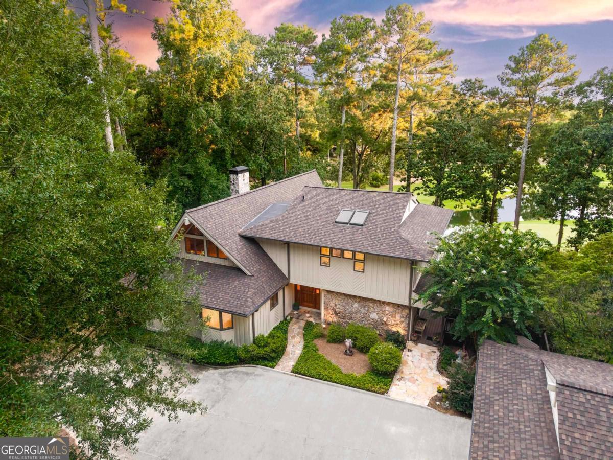 This beautifully maintained golf course home offers sweeping views of holes 2, 3 & 4 of The Landing course, a pond view, and looking down the fairway to the stunning water of Lake Oconee-views from this home are so exquisite, they have been featured in Reynolds Magazine Advertisements over the years. Designed with large, light-filled spaces and walls of windows, the open-concept layout brings the outdoors in. The main level features two bedrooms, a gourmet kitchen, and expansive living and dining areas perfect for entertaining. Enjoy peaceful mornings and breathtaking sunsets from the large multi-level wraparound deck. Ideally situated in The Landing of Reynolds Lake Oconee with access to world-class amenities, golf, lake life, and more. This is a rare opportunity to own one of the best view properties in the community. Seller makes a Club membership available for Buyer to explore how they can enjoy golf, sporting grounds, tennis, pickleball, fitness, recreational, and culinary amenities of a world-class private club.