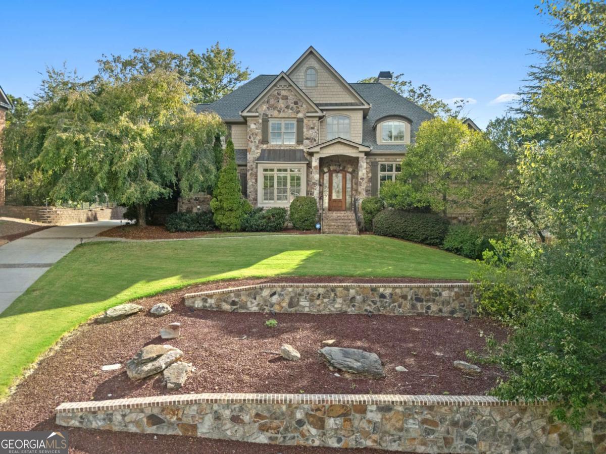 Welcome to an elevated lifestyle in the Spalding Stables Gated Community in Sandy Springs, where this beautiful four-sided brick home with a 3 car side entry garage and a master on main awaits. Step inside and discover an open and airy main level, bathed in natural light thanks to new windows and enhanced by plantation shutters, freshly sanded hardwood floors, and updated paint. The dramatic two-story foyer sets the stage for the home's refined interiors, while the chef's kitchen boasts custom cabinetry, granite counters, stainless steel appliances, a Sub-Zero refrigerator, a double oven, warming drawer, wine cooler, and a large island with a breakfast bar. This culinary haven flows seamlessly into a cozy keeping room and a spacious family room, both featuring fireplaces and access to a beautifully landscaped backyard with a pool, spa, and grilling area, creating a private oasis perfect for casual gatherings and grand entertaining. The main level also offers an oversized owner's suite, providing a luxurious sanctuary with direct access to the backyard, including a customized walk-in closet with built-in shelving and drawers, and a spacious en-suite bathroom. A formal dining room, complete with wainscoting and a tray ceiling, is perfect for hosting elegant dinners, while a convenient butler's pantry for effortless entertaining, a wet bar, walk-in pantry, mudroom, laundry room, and a private large study add functionality. Upstairs, four generously sized bedrooms offer comfortable accommodations, with two bedrooms featuring private bathrooms and the remaining two sharing a Jack and Jill bathroom, along with a versatile flex room that can adapt to your needs, whether it's an office, playroom, or media room. The Terrace level is an entertainer's dream, featuring a theater room, soundproof recording studio, gym, golf simulator room, den/office/game room, and much more, including two additional bedrooms with a Jack and Jill bath, making it perfect for visitors or multigenerational living.