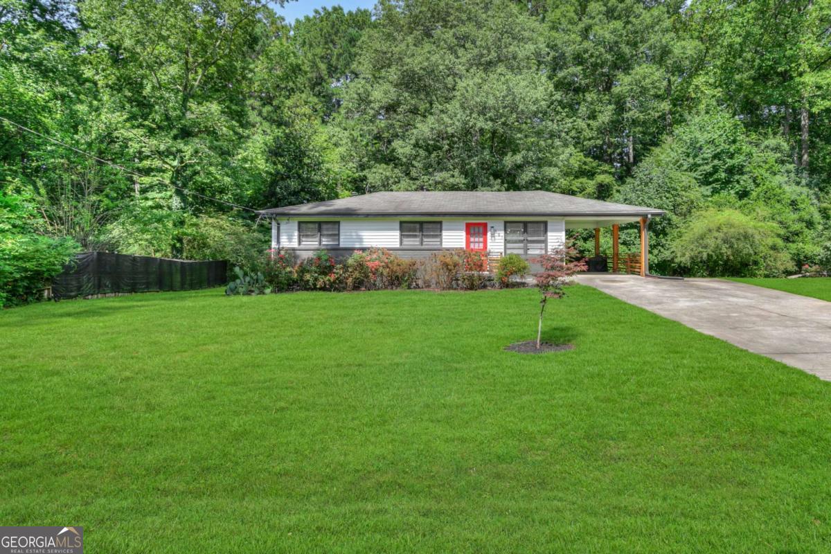 Remodeled Ranch Near Marietta Square! This stylishly updated 3 bed / 1 bath home is move-in ready and ideally located close to Marietta Square, KSU, Smyrna Village, and I-75. A charming front yard with blooming roses and great curb appeal welcomes you to a recently painted exterior, updated front door, and carport with new wood columns and railings. Step inside to original hardwood floors, new modern light fixtures, and an open floor plan. The renovated kitchen features stainless steel appliances, smart faucet, fresh butcher block countertops, accent tile, and a peninsula perfect for entertaining. The hallway leads to three bedrooms, including a spacious primary with a walk-in closet and ceiling fan. A sliding barn door opens to the newly-updated bathroom with floating double vanity, smart faucets, new tile, lighting, and accessories. Bonus: washer/dryer included! Upgrades include a 2+ year old HVAC system, updated electrical, and a newer water heater. Enjoy a large, flat backyard with a new fire pit, plus plenty of parking with an oversized double driveway and covered carport. No HOA! Just minutes from shops, restaurants, and more.