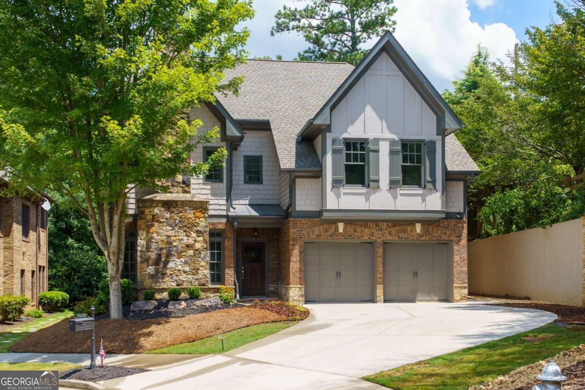 Welcome to 4786 Lakeway Place-a beautifully updated 5-bedroom, 4.5-bath Craftsman-style home by John Willis, nestled in the prestigious Parkside Manor community of Alpharetta. Ideally situated on a quiet cul-de-sac lot, this residence offers refined comfort, modern upgrades, and direct access to top schools, premier amenities, and scenic parks. Inside, you'll find refinished hardwood floors, fresh interior paint, and new carpet throughout. The expansive open-concept layout is enhanced by coffered ceilings, elegant millwork, and multiple fireplaces, creating a warm, welcoming atmosphere. A spacious formal dining room-complete with its own fireplace-comfortably seats 12+ and is perfect for hosting special occasions. The renovated chef's kitchen features granite countertops, stainless steel appliances, a breakfast bar, large pantry, and a butler's pantry. It flows seamlessly into the bright family room with a coffered ceiling, making it ideal for everyday living and entertaining. A main-level bedroom or sunroom with a full bath offers flexible space for guests, a home office, or a quiet retreat. Upstairs, the luxurious primary suite includes a cozy sitting area, vaulted ceilings, a spa-inspired bath with double vanity, and generous closet space. Additional bedrooms include a private ensuite and two bedrooms connected by a Jack and Jill bath. Outdoors, enjoy a flagstone-covered patio, landscaped backyard, and a charming side courtyard-all backing up to private trails leading directly into Webb Bridge Park. Recent upgrades include new exterior paint (2024) and a new roof (2024). Community amenities include a swimming pool, clubhouse, playground, and walking trails. This prime Alpharetta location is just minutes from Avalon, downtown Alpharetta, and GA-400, offering unmatched convenience and lifestyle. Zoned for top-rated Fulton County schools-Lake Windward Elementary, Webb Bridge Middle, and Alpharetta High School-this truly move-in ready home blends timeless architecture with modern features.