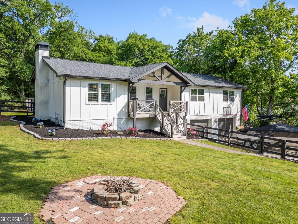 ***FULL 2024 HOME RENOVATION - INSIDE & OUT, FULL HOME WARRANTY, $10,000 TOWARDS CLOSING COSTS . MOVE IN READY WITH NO HOA ON OVER HALF AN ACRE*** This stunning 4-bedroom, 3-bath home was fully remodeled in 2024 from the ground up, giving you the peace of mind of a brand-new home without the wait. From the exterior to the interior, every detail has been thoughtfully updated so you can simply move in and enjoy. Step inside to find all-new flooring, modern updated bathrooms, and a gorgeous chef's kitchen with quartz countertops and a huge island, designed for everyday living and entertaining. The spiral staircase adds a one-of-a-kind architectural touch, while the rare traditional floorplan-NOT a split-level-offers a seamless flow of space that feels open, bright, and inviting. The finished lower level features a full bath and large open bedroom with private entrance- an excellent space for guests, a home office, or a creative studio. Relax on the front porch and take in the serene pond view, ideal for morning coffee or evening sunsets. Outside, you'll love the huge, level backyard-ideal for gatherings, play, or relaxation. The property also includes ample outdoor storage, a powered and insulated workshop, and a covered outdoor space-perfect for entertaining, hobbies, or keeping your toys and vehicles protected year-round. This move-in ready home also comes with a full home warranty and $10,000 towards closing costs. With no HOA restrictions, Cherokee County schools, and a location just minutes from shopping, dining, parks, and Downtown Woodstock, this property truly has it all. Don't miss your chance-Discover this immaculate home in person and schedule a visit today.