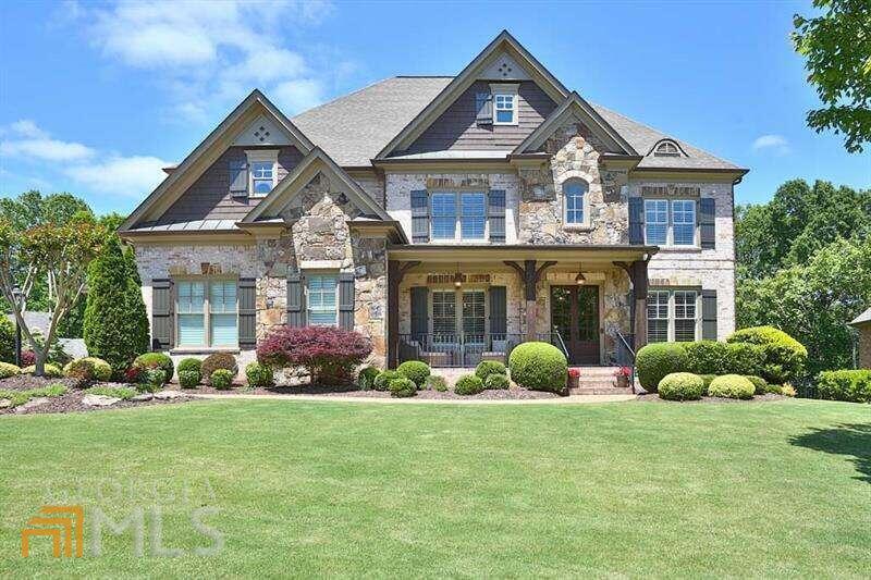 Fantastic opportunity to purchase an exquisite custom-built 7 bedroom/6 bath home in the sought-after Lambert High School district! Four sided brick estate home located within the gated Turnberry Subdivision, a swim/tennis community. The main level boasts a gourmet chef's kitchen with an oversized granite center island, built-in refrigerator, induction cooktop stove, convection double ovens, and custom cream painted cabinets. The large open floor plan includes views from the kitchen of the keeping room with stacked stone fireplace, vaulted ceilings and custom wood beams. Great Room upgraded with coffered ceilings, built-in bookshelves and an additional fireplace. Finely appointed private office with glass doors and judgeCOs paneling. Gracious formal dining room with custom millwork. Full bedroom and bath on the main floor. Master suite is upgraded with his and her closets, oversized master bath with separate tile shower, granite countertops and custom wood cabinetry. Large secondary bedrooms located upstairs with upgraded baths. Fully finished terrace level with plenty of space to entertain including a full bar, billiards area, shiplapped drink rail, additional keeping room with a stone fireplace, home entertainment area with exposed brick walls, additional ensuite guest room on terrace level. The home has been upgraded throughout including side entry mudroom with built-in backpack storage nooks, fresh paint, custom wood beams in keeping room & basement, 8 foot doors, shiplapped walls & ceilings, custom millwork, two levels of covered outdoor decks, coffered ceilings, double hardwood entry doors, fully fenced private backyard with creek views, three car garage. Award winning public schools!