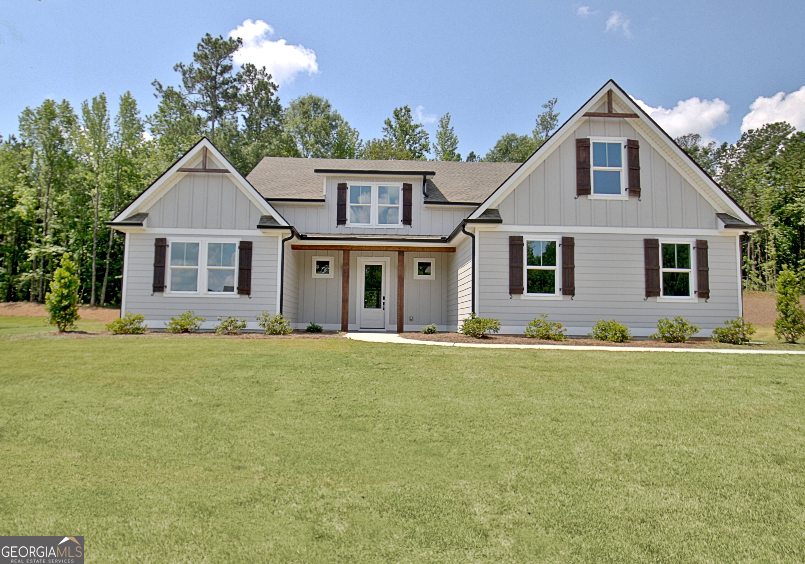 Experience luxury, comfort, and low-maintenance living in this stunning custom-built home by Barentine Downing Construction Inc., located in the desirable Greyfairs Community. Designed with both elegance and practicality in mind, this home features durable concrete siding with vinyl soffits, ensuring easy upkeep. A tankless water heater provides endless hot water, while the full-yard sprinkler system maintains the lush Bermuda sod in both the front and backyard year-round. As you arrive, the three-car garage offers ample space for vehicles and storage, with two convenient entry points leading into the home. Step inside through the inviting foyer, where a double drop zone provides the perfect space for organization. To the left, two spacious guest bedrooms and a full bath offer privacy and comfort for family and visitors. Continuing down the central hallway, you'll find a storage closet and a staircase leading to the upper level, which features a media room, bonus room, an additional bedroom, and a full bath-a perfect space for entertaining, working, or relaxing. The great room is the heart of the home, filled with natural light that enhances its warm and inviting ambiance. The floor-to-ceiling stone fireplace with a gas starter serves as a striking focal point, while the open-concept design allows for effortless flow and flexible furniture placement. Just beyond, the spacious covered back porch offers the ideal setting to enjoy the peaceful outdoor surroundings. The gourmet kitchen is designed for both beauty and function, featuring custom cabinetry throughout the home, a large breakfast bar, a gas stove with a vent hood, a microwave drawer, a dishwasher, a farmhouse sink, and a pantry. The nearby laundry room is equally impressive, offering cabinetry above the washer and dryer for additional storage, along with a second entryway into the garage for added convenience. The primary suite is a true retreat, complete with wood beam accents, a ceiling fan, and picturesque views of the beautifully landscaped backyard. The spa-inspired ensuite bathroom features a slipper tub, double vanity with stacked drawers, a stepless entry tiled shower, private toilet room, additional shelving for storage, and a custom closet system for effortless organization. This exceptional home offers a perfect blend of craftsmanship, functionality, and style. Don't miss the opportunity to experience the superior quality of Barentine Downing Construction Inc.-schedule your visit today!