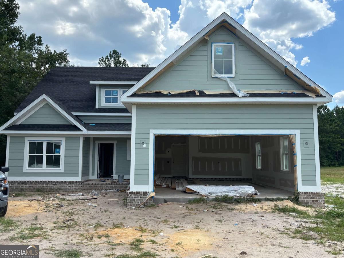 Located in the beautiful community of River Oaks, this brand-new construction offers 5 bedrooms and 3 bathrooms on a spacious 0.64-acre lot. Designed with both comfort and functionality in mind, the home features LVP flooring throughout and welcomes you with a charming front porch that leads into a foyer and a cozy living room complete with a fireplace. The kitchen is equipped with stainless steel appliances and includes a walk-in pantry with built-in wooden shelving, flowing into a dining room. A mudroom and laundry room add everyday convenience. The main-level primary suite boasts trayed ceilings and a luxurious en suite bath with double vanities, a separate tiled shower, soaking tub, and a walk-in closet with custom wooden shelving. There is also a second bedroom/office that round the first floor out. Upstairs, you'll find three spacious guest bedrooms including a massive bonus room and full bathroom. A two-car garage and rear porch complete this thoughtfully designed home in one of the area's most desirable neighborhoods. Estimated completion Sept. 2025.