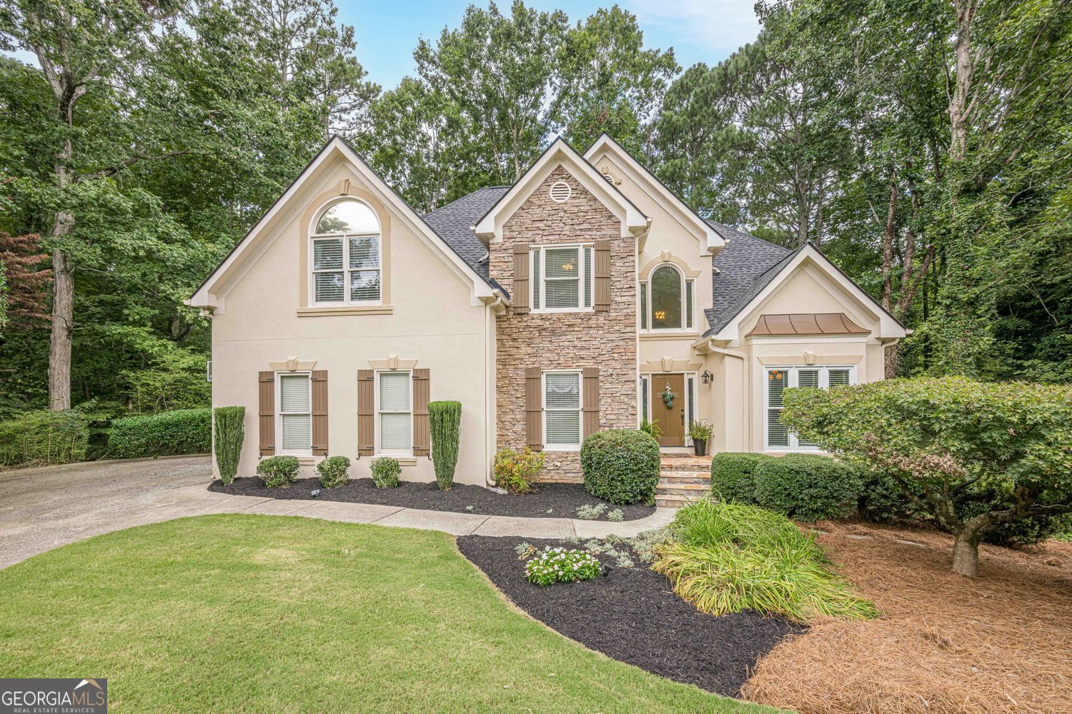 Welcome to 3345 Cherry Oak Lane - Master on Main, Screened Porch, in Cul-de-sac on Quiet Street in South Forsyth County Nestled in a peaceful cul-de-sac on a wooded lot with a serene creek, this beautiful home offers space, comfort, and convenience in one of Forsyth's most desirable locations. The inviting floor plan features a spacious vaulted great room, perfect for entertaining, that flows seamlessly to a screened porch plus opened deck for grilling and dining. The kitchen boasts custom cabinetry, granite countertops, a breakfast room, and a formal dining room for gatherings. NEW ROOF & WATER HEATER 2025 The large primary suite on the main level includes an updated bathroom with view to private wooded backyard. A generous laundry room is also located on the main floor for added convenience. Upstairs, you'll find three additional bedrooms and a full bath. The finished basement offers incredible flexibility with a media room, office, possible 5th bedroom or guest room, music room, and abundant storage. Walk out to flagstone patio where you can take in nature. Additional highlights include a side-entry garage, level driveway, and mature landscaping that enhances the property's curb appeal. Located near top-rated Forsyth schools, parks, shopping, dining, the library, and more, this home combines privacy with convenience in an unbeatable setting.