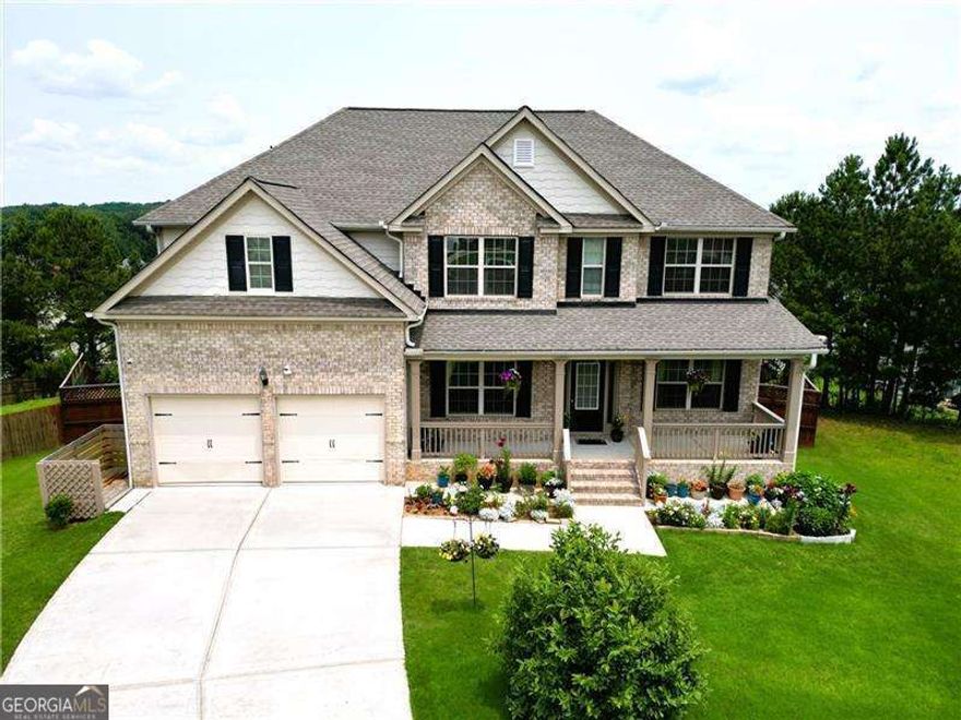 Welcome to this one-of-a-kind, no-expense-spared residence in the highly sought-after swim and tennis community of Pine Grove. Situated on one of the largest lots in the neighborhood, this cul-de-sac home is just a short walk to the clubhouse, pool, and tennis courts.  The fully finished terrace level is ideal for multi-generational living, complete with a second kitchen, family room, bedroom with walk-in closet, full bathroom, laundry hookups, and a spacious rec/media room.  A charming rocking chair front porch welcomes you into a gracious foyer flanked by a formal living room and a banquet-sized dining room with coffered ceilings. The fireside great room seamlessly flows into the casual dining area and chef's kitchen, featuring white cabinetry, granite countertops, and upgraded appliances-including a double oven, gas cooktop, refrigerator, microwave, and dishwasher.  A main-level bedroom and full bath offer convenience and flexibility. Upstairs, you'll find four additional bedrooms and three full baths, plus a bonus room that can serve as a fifth bedroom with closet space. The spacious owner's suite boasts trey ceilings, dual walk-in closets, and a luxurious en suite bath with double vanities, soaking tub, and separate shower.  The beautifully landscaped, fully fenced backyard includes a custom-built she-shed with a loft and built-in shelving, an upgraded deck with stairs and landing, and an extended concrete patio for even more outdoor living space.  Additional highlights include three HVAC systems and three water heaters for optimal comfort and efficiency.  Don't miss your chance to own this exceptional home in Pine Grove!