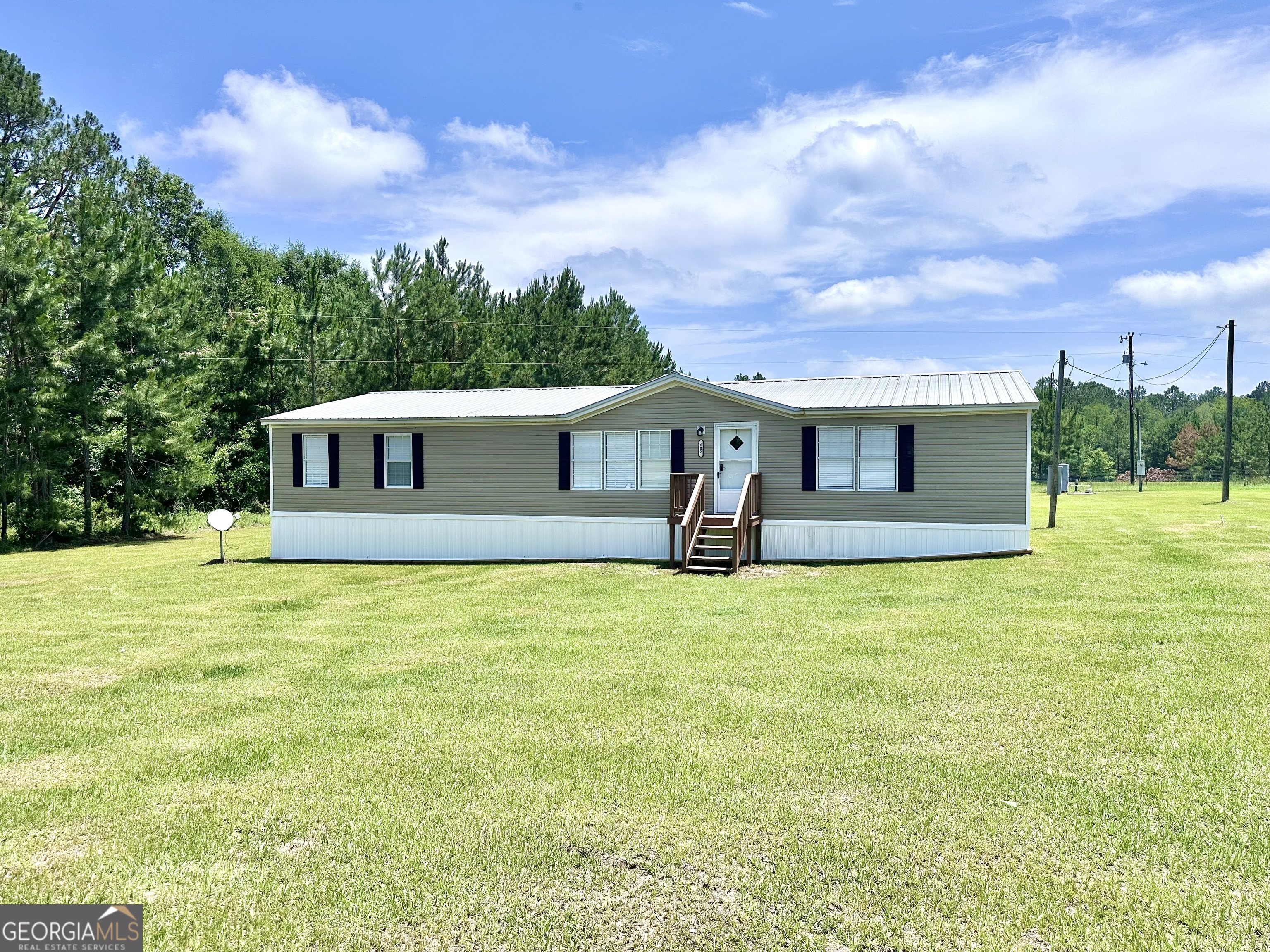 Welcome to this beautifully updated 3-bedroom, 2-bathroom mobile home situated on a spacious 1-acre corner lot in Claxton, GA - just 20 minutes from Metter! Built in 2001 and offering an impressive 2,084 sq. ft. of living space, this home combines modern updates with comfortable country living. Step inside to find fresh paint throughout, brand new flooring, and a huge living room perfect for relaxing or entertaining. The kitchen features stylish butcher block countertops and updated fixtures, making it as functional as it is beautiful. The split floor plan ensures privacy, with a large primary suite and two generous guest bedrooms. Additional highlights include a durable metal roof, updated lighting and hardware, and a large yard with endless potential - whether you're looking to garden, build a workshop, or simply enjoy your own space.Don't miss out on this turn-key home in a peaceful setting - schedule your showing today!
