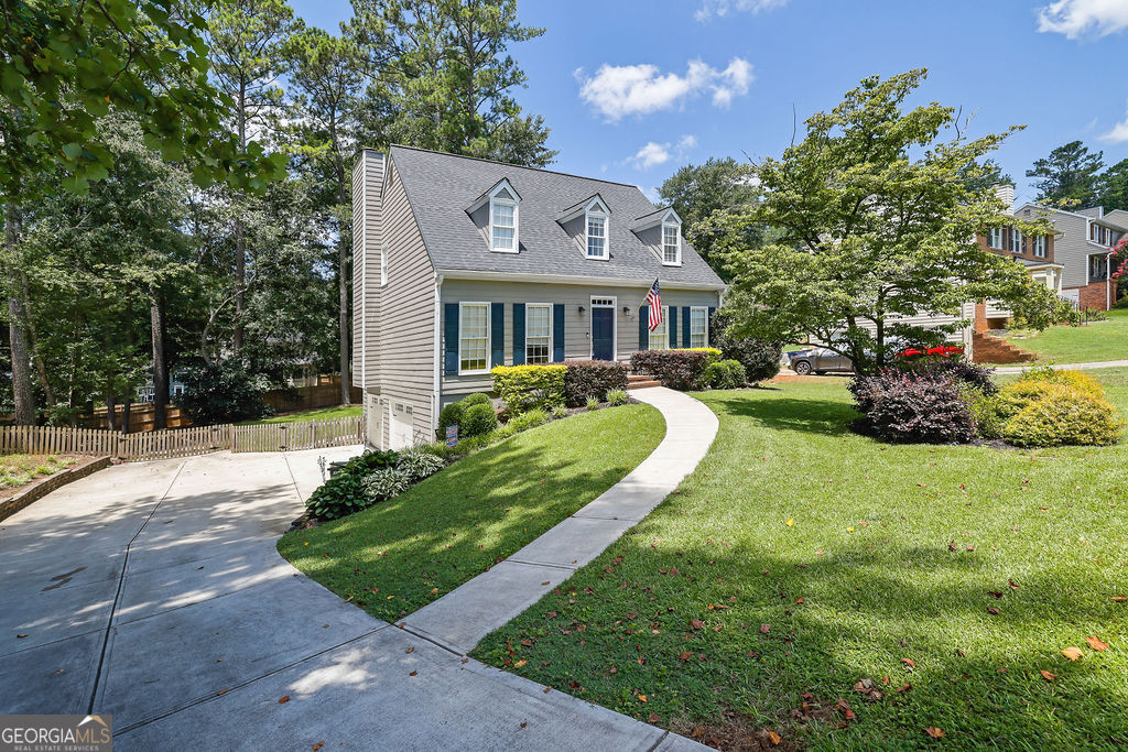 Welcome to this Beautifully Maintained home in the highly sought-after Walton High School District nestled in the established Mitsy Forest subdivision! Situated on a private, manicured lot, this property impresses from the moment you arrive with its new driveway, fresh exterior paint, and lush landscaping. Step inside to find new LVP flooring on the main level. The foyer is flanked by a formal dining room and a spacious flex room perfect for a home office or library. The heart of the home is the family room featuring built-in bookcases! The fully renovated kitchen is a dream with new cabinetry, a large island with seating, a breakfast nook, and seamless flow to the formal dining space - ideal for entertaining and everyday living! Upstairs, you'll find three generously sized bedrooms, each with ample closet space. The updated hall bathroom features updated tile work, upgraded vanity, and designer lighting. The primary suite is a true retreat with a glass-enclosed tile shower, dual vanities, and modern finishes. The finished basement offers a huge, flexible space perfect for a media room, home office, or playroom. It also includes a mudroom nook with direct access to the oversized side-entry two-car garage with tons of storage. Enjoy the outdoors from the screened-in back porch, perfect for relaxing year-round, or step onto the open grilling deck that overlooks the fenced backyard--perfect for children or pets! Located in a quiet, amenity-rich community with swim and tennis, this home offers both convenience and lifestyle! Don't miss your opportunity to own in one of East Cobb's most desirable locations! Call today for your private showing!