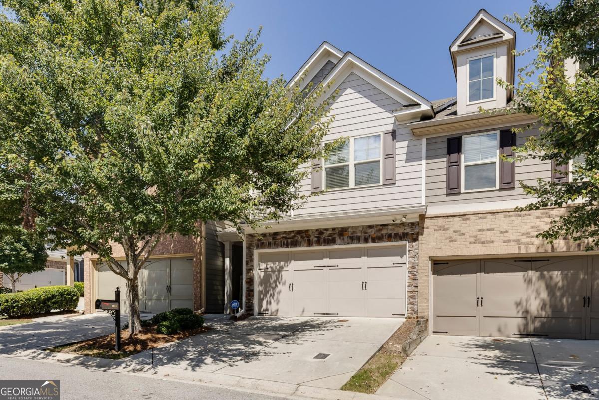 Beautifully maintained home with over $30,000 in upgrades. Upgrades include: 2024 premium 2 zone AC with separate up/down thermostats that can be controlled via phone app: 2020 new premium hardwood floors throughout; 2020 interior paint, 2023 new stainless steel refrigerator, 2025 painted kitchen cabinets, new blinds on main level and 2 new ceiling fans. The main level offers desirable 9' smooth ceilings and an open floor plan with a stepless entry from the 2 car garage that fits full-size SUVs. The welcoming foyer leads to the seamless living room with coffered ceilings, a cozy electric fireplace with stone hearth, built-in bookcase and a view to the dining room, kitchen and backyard which is ideal for entertaining or everyday living. The kitchen and dining room are bright with plenty of natural light streaming through windows, white cabinetry, island, stainless steel appliances, walk-in pantry and a french door to a lovely fenced yard with a grilling patio. There's a spacious owner's entry from the garage, with a coat/storage closet and half bath. As you travel up the hardwood steps you'll notice that the upstairs level has the same beautiful hardwood flooring as the main level. The primary bedroom retreat has plenty of room for a king size bed plus a bonus sitting area and private en-suite with separate soaking tub/tiled shower, double vanity and walk-in closet. Secondary bedrooms have good closet space and a shared full bath. Outstanding swimming pool community. A perfect blend of easy living, stylish comfort and unbeatable location. Fast access to 285/75, Battery, Silver Comet Trail, Smyrna Village Green, downtown, airport, shopping and restaurants.