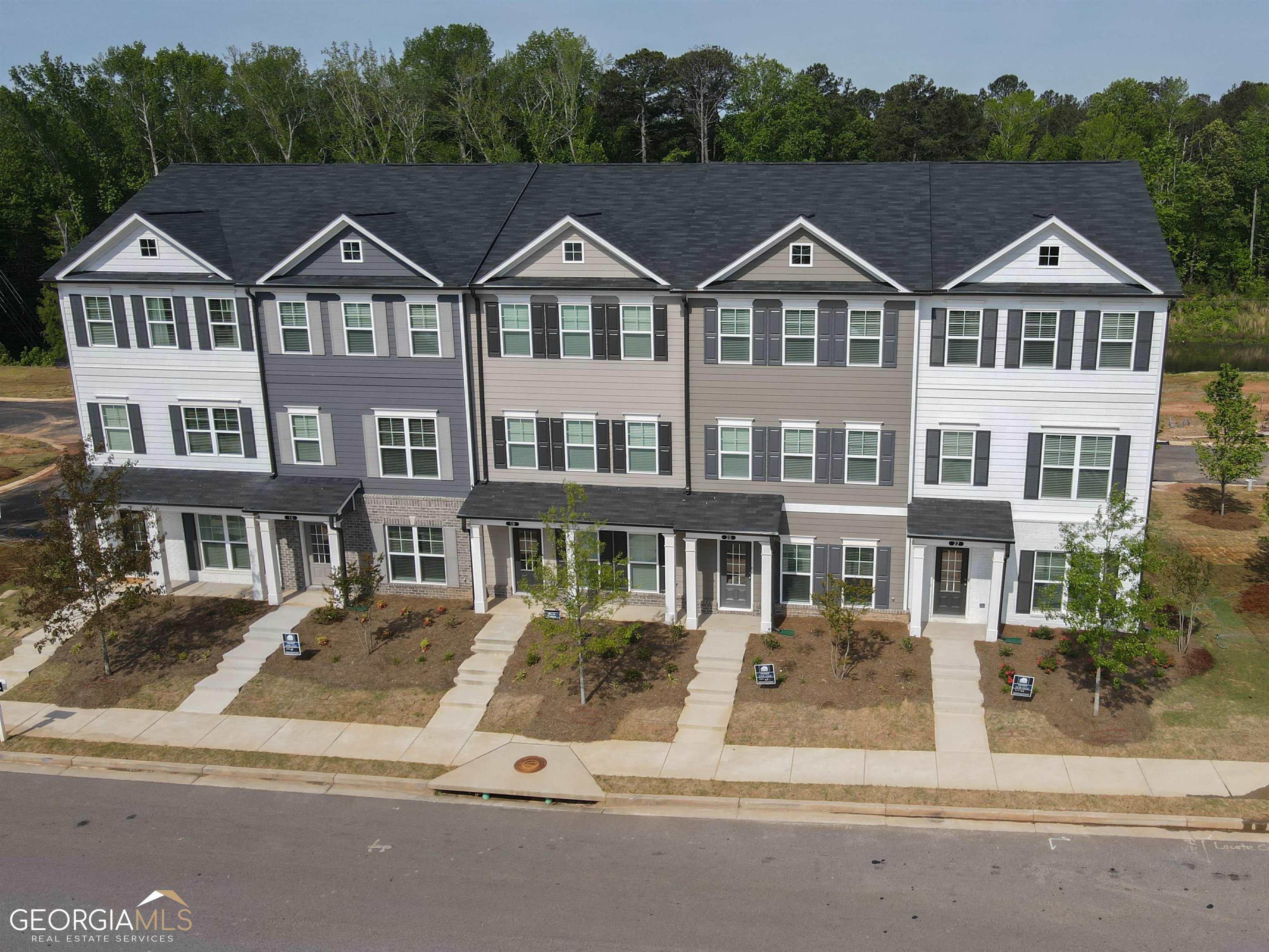 ASK US HOW YOU CAN OWN THIS HOME WITH ZERO DOWN PAYMENT!! New Construction on the LINC Trail! Nickel Creek @ Newnan Crossing! The End Unit Eaves floor plan features a beautiful three-story, three-bedroom, 3.5 baths, 42" cabinets, crown molding, kitchen backsplash, granite countertops, 2" faux blinds, and stainless steel appliance package with a two-car rear entry garage with remotes. The community is conveniently located near shopping, dining, and Interstate I-85. The seller offers $7000 in buyers incentive with the preferred lender South State Bank.