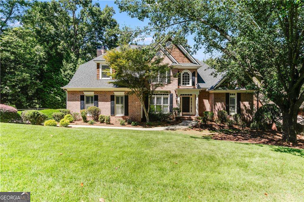 Experience the lifestyle you've been dreaming of in this beautifully maintained brick-front home located in the sought-after Harbour Point Yacht Club community. Step inside to find a spacious layout featuring a formal dining room and a flexible front living space that can easily serve as a home office or sitting area. The two-story great room is filled with natural light and opens to an eat-in kitchen, creating a warm and inviting space for everyday living and entertaining. Just off the kitchen, a large deck offers the perfect spot to enjoy your morning coffee or unwind in the evening. The home also features a brand-new HVAC system for the first floor, ensuring year-round comfort and efficiency. One of the standout features of this home is the main-level primary suite, offering both luxury and convenience. Perfect for those who prefer to avoid stairs, this spacious retreat includes a spa-inspired bathroom with dual vanities, a jetted tub, a walk-in shower, and his-and-her closets-making it ideal for long-term comfort and accessibility. Upstairs, three additional bedrooms include a Jack and Jill bath, flexibility, with space for a teen or in-law suite, a gym, a game room, or a bunk room, plus a full bath and generous storage areas with soaring ceilings-ideal for seasonal items and more. Already included in the basement is a large screen home theatre room. Harbour Point offers a gated, resort-style living experience with amenities including a staffed security gate, clubhouse with seasonal grill, a pool overlooking Lake Lanier and the North Georgia Mountains, pickleball and tennis courts, a playground, and year-round community events. Located between Gainesville and Dawsonville, you'll enjoy easy access to breweries, shopping, dining, concerts, and farmers markets, as well as the natural beauty of the North Georgia Mountains, hiking trails, waterfalls, wineries, and distilleries. HOA fees are $908 per quarter, and this home comes with a dock slip for purchase, so there's no waitlist required. Discover the perfect blend of comfort, convenience, and community in Harbour Point.