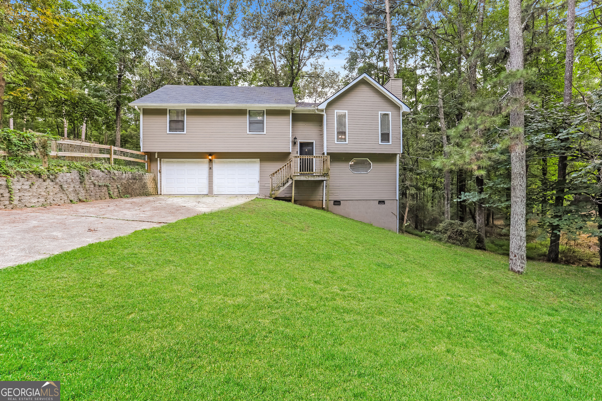 Welcome to this quaint 3 bedroom 2 bath home. Open living room with vaulted ceilings featuring a beautiful stone fireplace. Large Primary suite with garden tub and separate shower. Sizable secondary bedrooms and bath. Lower level large finished room that can be used as a bedroom, bonus room, family room or storage. Patio overlooks the large, wooded back yard. A great value starter home in a good School District!