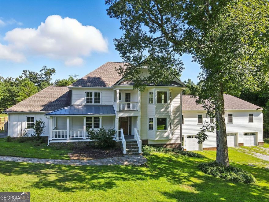 Five acres. A saltwater pool and spa. Stables and a guest house. This Canton estate delivers six bedrooms, six and a half baths, and every space you need-inside and out-for family, friends, and privacy.  The main level welcomes you with wide-plank wood floors, natural light pouring through large windows, and two stone fireplaces that anchor the living spaces. Here you'll find a bedroom, two full baths, and a half bath, including a private in-law suite. The kitchen opens to a sunny breakfast nook and dining room, while the brick-floored sunroom and a practical mudroom add both charm and function.  Upstairs offers three bedrooms and two baths, including the primary suite with a walk-in closet and a spa-like bath. Additional bedrooms provide the flexibility to create home offices, guest rooms, or play space. The finished basement is a true extension of the home with a full bath, a fireplace-lit living room, wet bar, office, and flex space. It's the perfect spot for a teen suite secondary living area.  Outdoors, the property becomes a private resort. The saltwater pool with spa and slide is the centerpiece, surrounded by fenced acreage and wide-open views. Connected to the pool house, the barn features stables for horses and generous storage. The pool house also includes a convenient half bath. Above it, a full guest suite offers one bedroom, one bath, a kitchen, and dining area-perfect for long-term visitors or weekend stays. A large screened porch ties everything together, creating the ultimate space for outdoor dining and relaxation.  With a three-car garage, equestrian facilities, resort-style amenities, and a versatile floor plan, this estate blends luxury, privacy, and everyday comfort-all just minutes from Canton's conveniences.