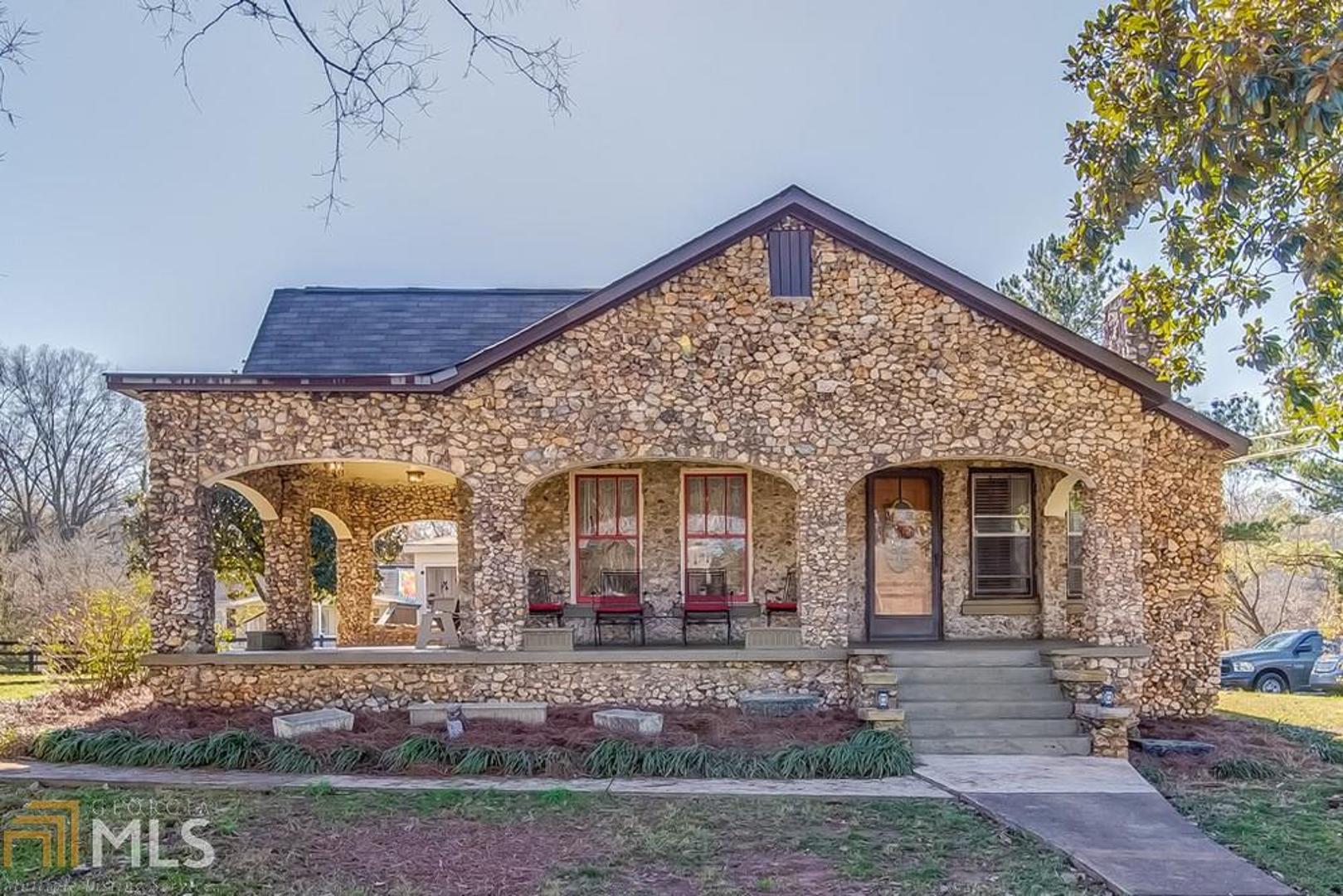 Unbelievably Charming! This renovated 1930s era. stone abode will catch your eye. Perfectly placed on a 1-acre corner lot in the center of Adorable Lindale Georgia. The renovated open floor plan, refurbished Pine HW floors & Stainless appliances help bring this classic 2BR,2BA Gem fully into the modern world. The new screened and attached open air porch is accessible via the MBR. The wrap around front porch is accessible from LR & KIT. And Yes, the Beautiful new shed/storage building in the corner of this oversized lot is Included, and ita???s just what youa???ve been needing! Although ita???s move-in ready, the homes potential is limitless! New moisture barrier and a transferable termite bond are accompanying the home. DO NOT miss out on one Lindalea???s most charming homes! Schedule your showing today!
