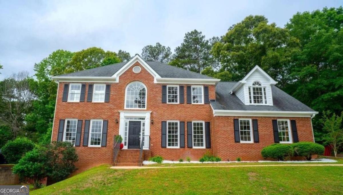 Welcome to this stunning, move-in ready home in the desirable Sentinel West subdivision of Marietta, perfectly situated on nearly half an acre, on a full basement, and just steps away from the community amenities, including a pool and tennis courts. With summer just around the corner, now is the perfect time to enjoy everything this property has to offer. Boasting a classic brick front, established landscaping, a two-car side-entry garage, and an inviting front stoop, this home impresses from the start. Inside, a soaring two-story foyer leads to a formal dining room with elegant wainscoting, a formal living room, and a spacious family room featuring a wood-burning fireplace and French doors that open to a bright, airy sunroom. The sunroom overlooks the expansive, fenced-in backyard with wooded views and no rear neighbors for a private retreat you can utilize year around. The oversized eat-in kitchen is the heart of the home, complete with granite countertops, high-end stainless steel appliances, a wine rack, large island that seats up to six, and a stunning floor-to-ceiling Palladium window that floods the dining area with natural light. Upstairs, you'll find a luxurious primary suite featuring tray ceilings, plantation shutters, spa-like bathroom with split vanities, free-standing soaking tub, large frame-less shower, and a must-see walk-in closet. Three additional generously sized bedrooms and an additional full bathroom complete the upper level. The fully finished basement offers a private entry and covered patio with limitless potential. Ideal for in-law or guest quarters, a young adult apartment, or the ultimate entertainment zone where you'll look forward to hosting friends and family after a day at the pool! Fire up the grill and enjoy the expansive deck, perfect for kicking back and relaxing on your favorite outdoor furniture. With tasteful updates throughout, including modern fixtures and elegant trim work, this home rivals new construction in both style and comfort. Located near recreational facilities, healthcare, shopping, local favorites, lots of grocery options, and the scenic walking trails of Kolb's Farm, this home combines convenience with a lifestyle of leisure and community. Don't miss the chance to call this beautiful home yours!